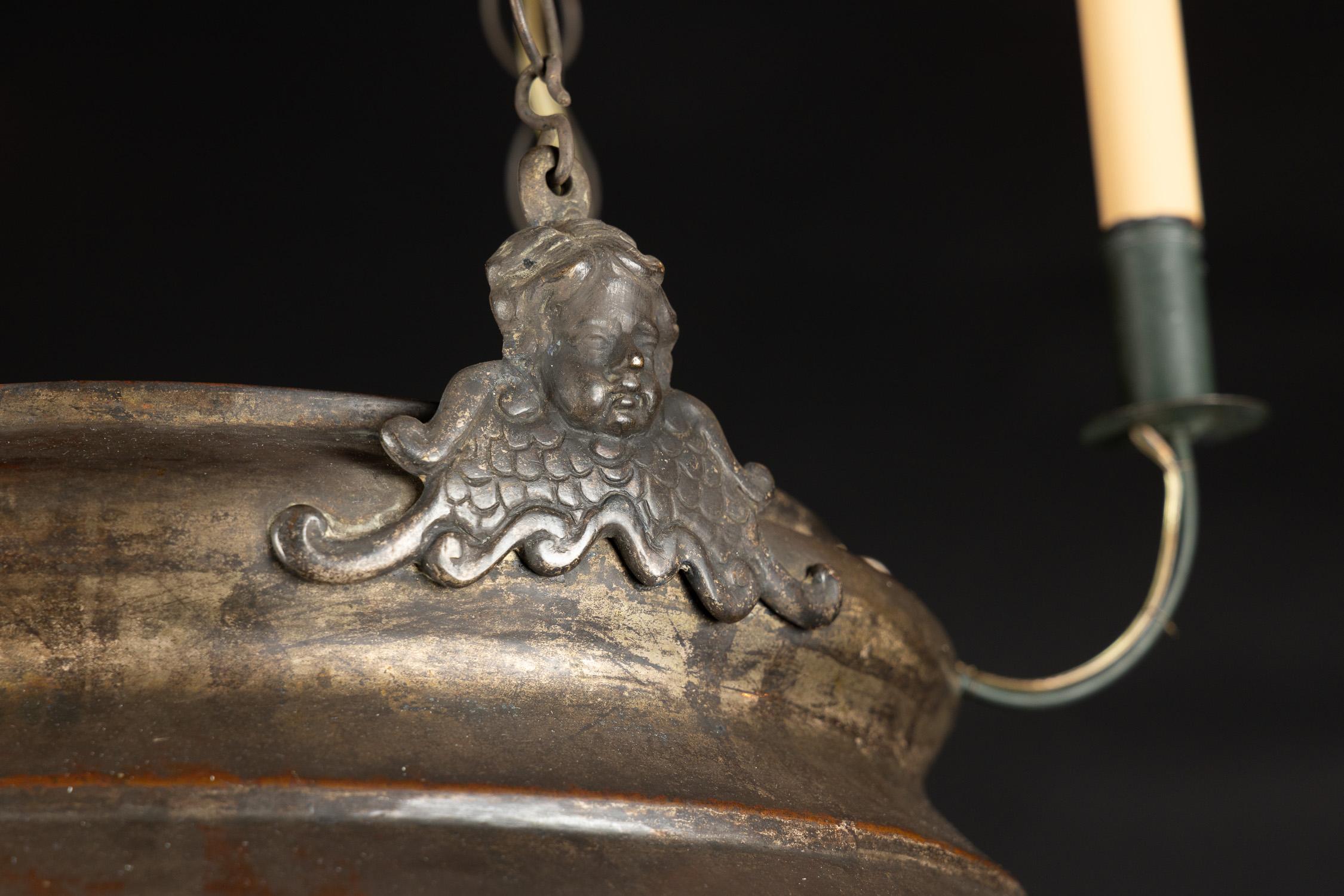 This grand hanging lantern was once an incense burning sanctuary lamp, and is made of brass sporting a beautiful dark patina. The French antique piece dates back to the 19th century and is embellished with hand-chiseled Moorish designs on the large