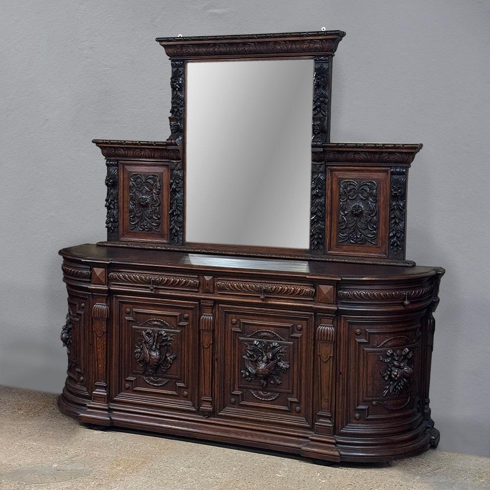 Grand 19th Century Renaissance Revival Mantel Mirror will make a powerful impression in any room!  The large mirror centered between two lavishly carved panels provides a tri-panel effect, great for larger surfaces and rooms.  Bold molding dominates