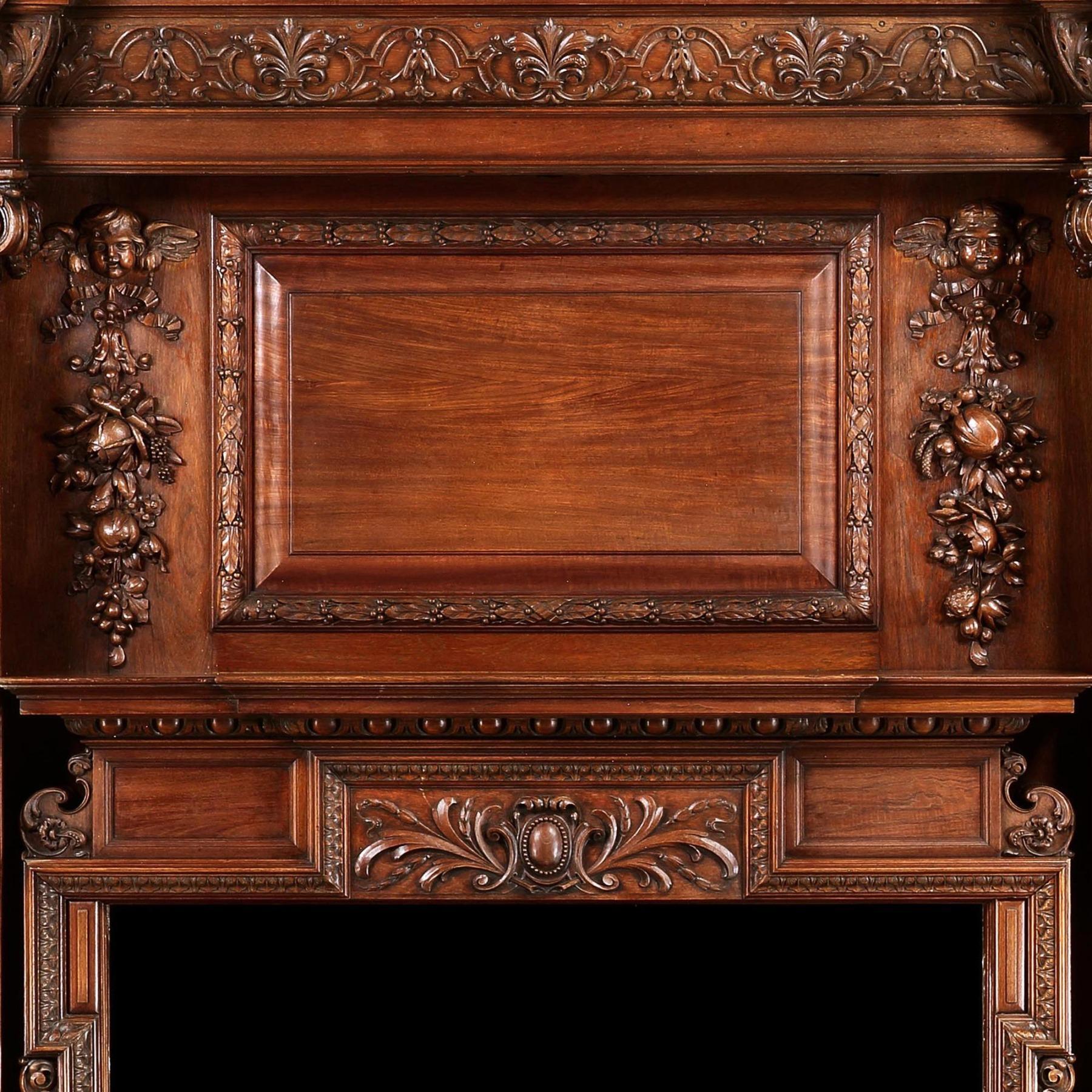 An imposing 19th century carved walnut fire surround with combined overmantel of large proportions standing over 8 1/2 feet high.



Scottish Circa 1860.



The carved breakfront moulded cornice sits above a rectangular fielded panel with