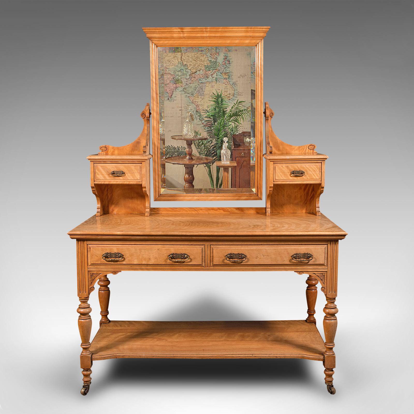 This is a grand antique dressing table. A Scottish, satinwood bedroom vanity stand with mirror by Taylor & Sons of Edinburgh, dating to the late Victorian period, circa 1890.

Impressive proportion and figuring to this striking dressing