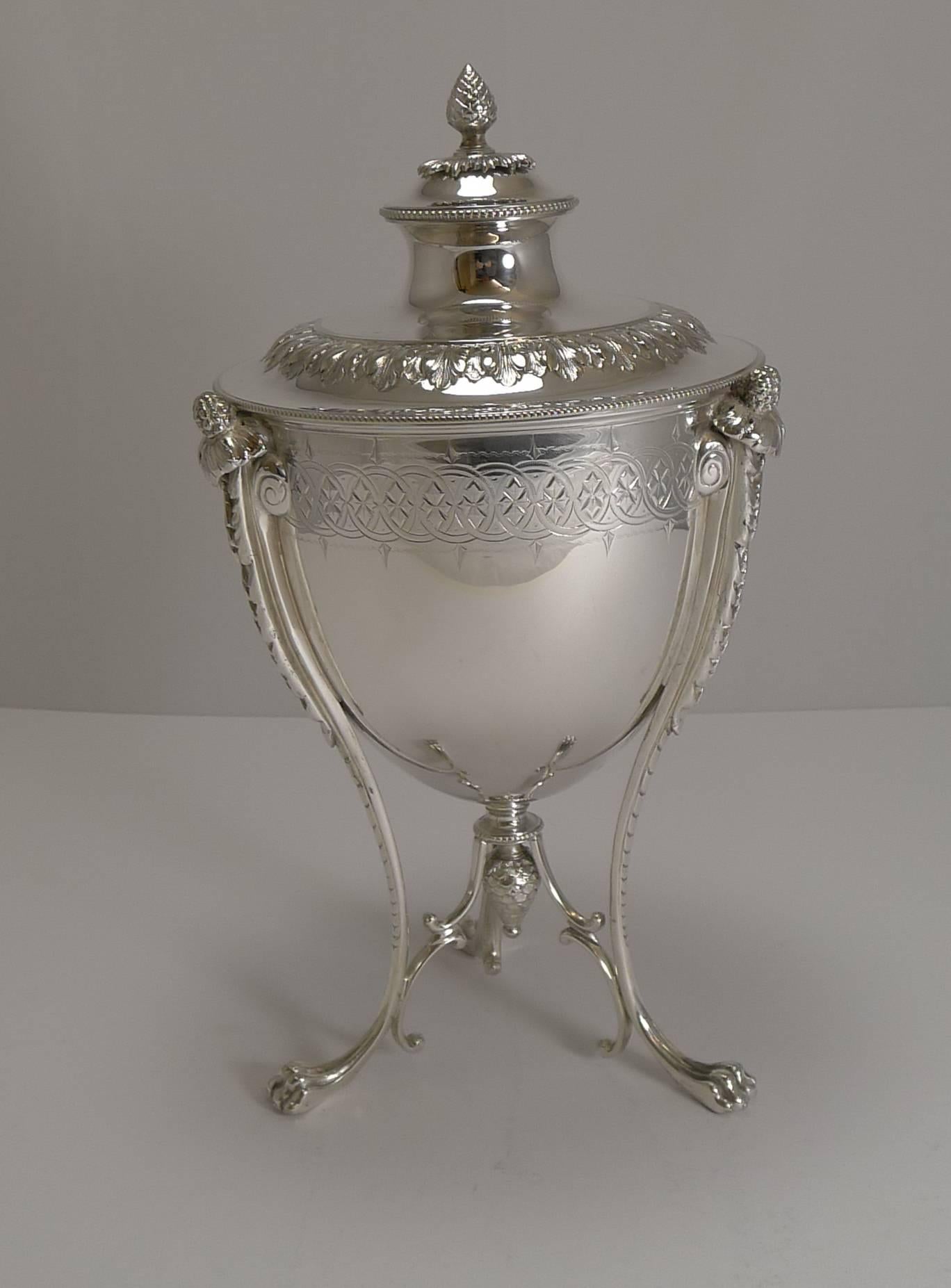 An absolutely stunning and most unusual Victorian biscuit box made in silver plate by the well renowned silversmith, Martin Hall & Co.

The three elegant tall legs terminate in Lion's paw feet and lead upwards to a floral and foliate terminal to
