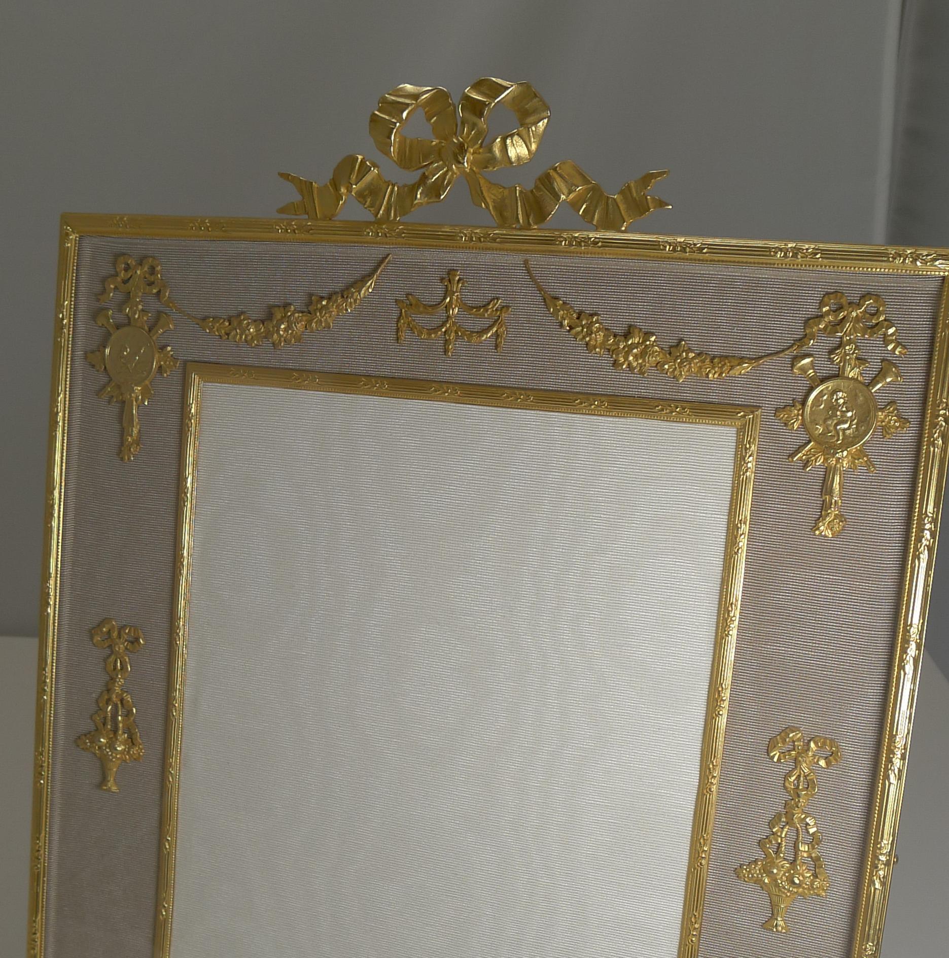A grand large antique Ormolu photograph or picture frame, the bronze smothered in gold, beautifully restored to it's former glory and ready to enjoy for the next 100 years and beyond.

The glazed front protects the taupe colored silk taffeta