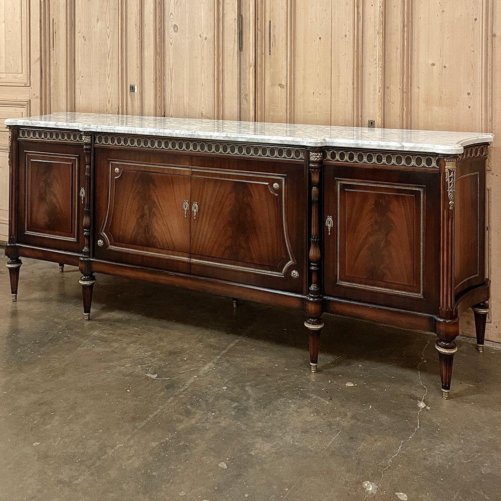 Grand Antique French Louis XVI Mahogany Buffet with Carrara Marble is ready to make a statement in your favorite room!  Stretching over eight and a half feet wide, it features concave sides and a step-front center section that combine to produce