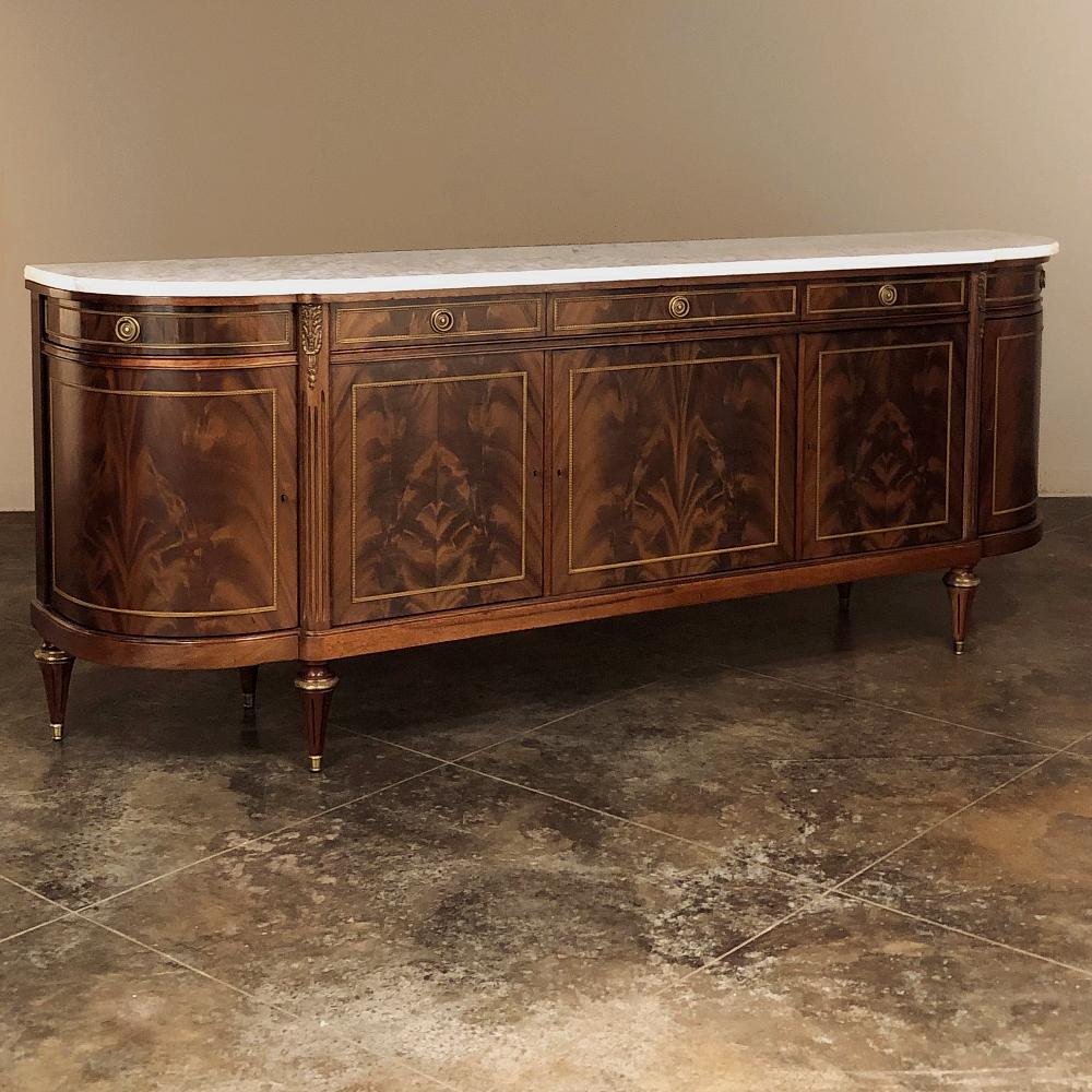 Grand antique French Louis XVI Mahogany marble top Buffet was hand-crafted from exotic imported mahogany, and features a large scale yet with rounded ends to minimize impact on your floor plan. The rounded sides are cabinet doors, too, that open to