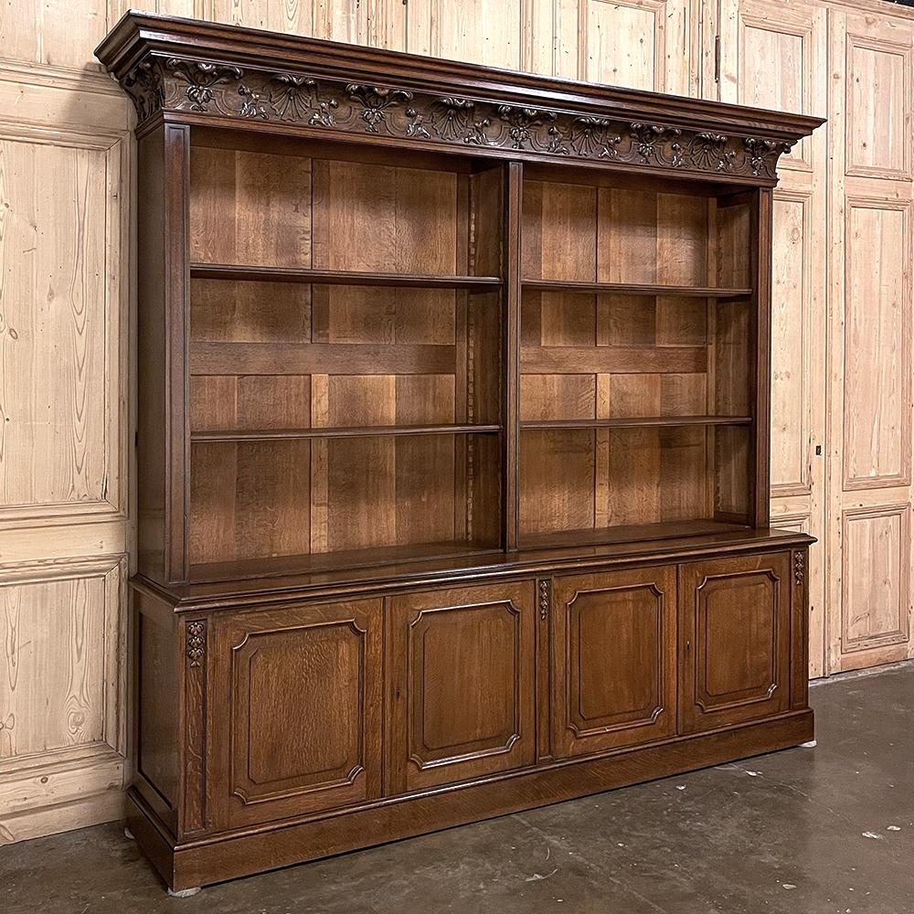 Grand Antique French neoclassical open bookcase will make an impressive piece in any room! The bold crown molding immediately catches one's attentions, with bold molding above a frieze consisting of boldly carved shell and foliates in a Corinthian