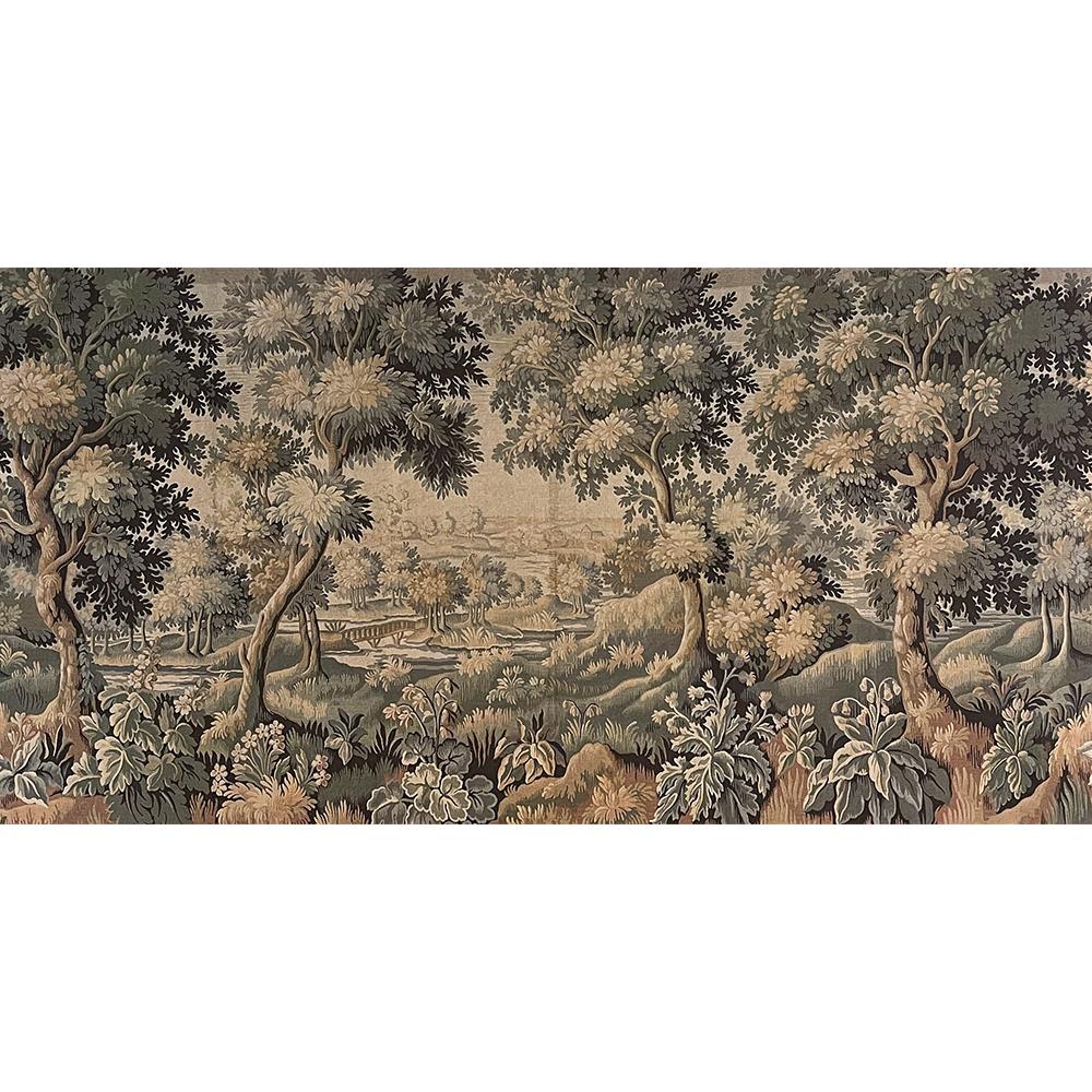 Grand Antique French Tapestry by Gobelins of Paris is a stunning panoramic landscape scene depicting a lush wooded area on the outskirts of a rural village.  Crafted on a large scale, it spans almost seven and a half feet tall by almost thirteen