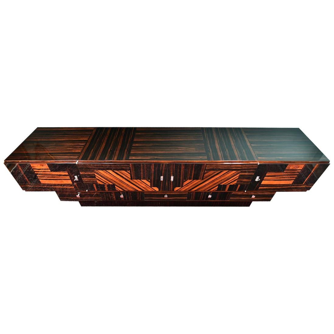 Grand Art Deco French sideboard in Macassar wood
Sideboard has exceptional inlaid wood work that is proudly displayed on the front of the sideboard. Sideboard is made out of 3 rectangular forms that are placed one on top of other. Upper part has 4