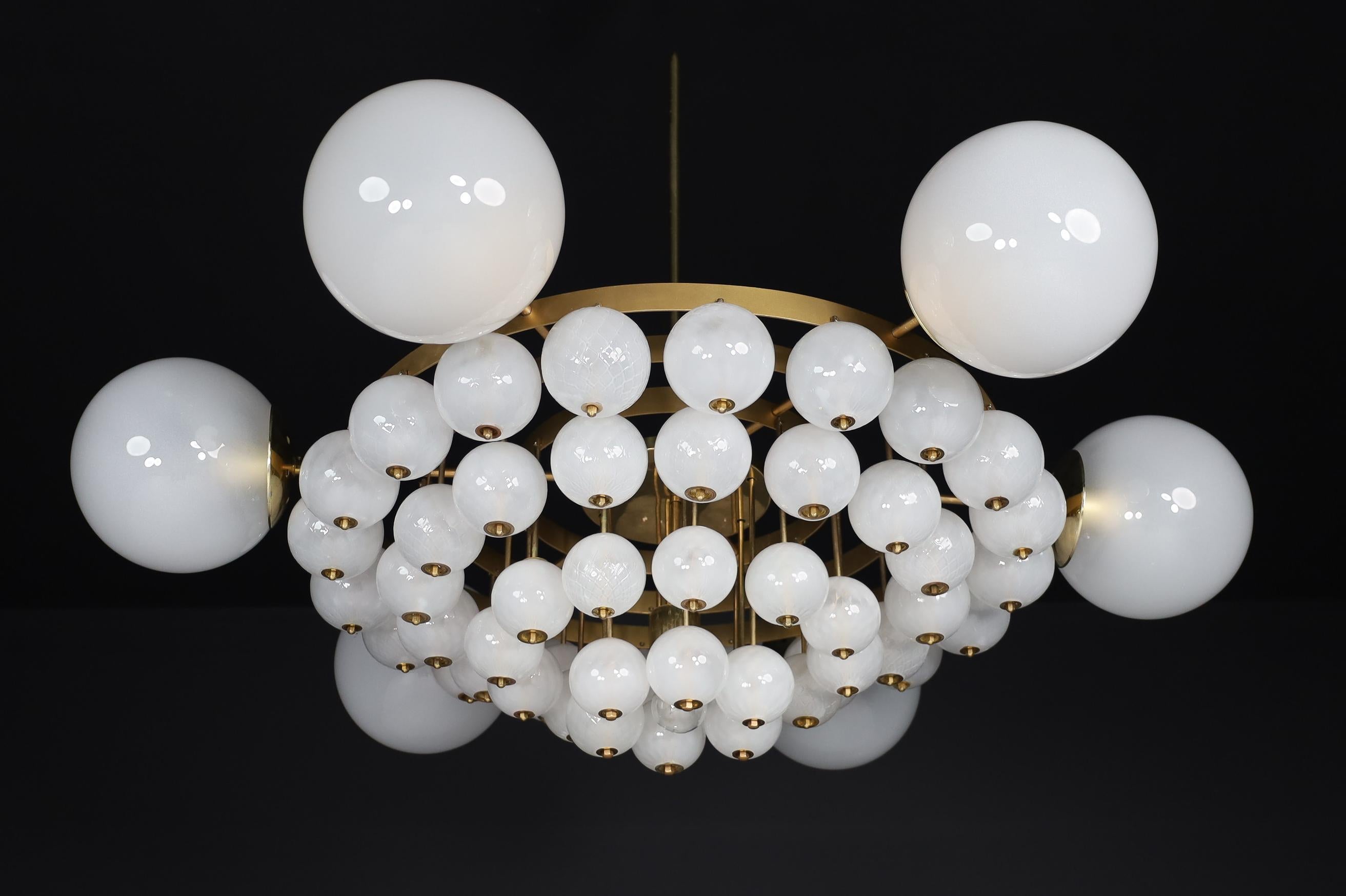 Grand Bohemian chandelier with brass fixture and hand-blowed frosted glass globes, Czechia 1960s 

Grand Bohemian chandelier with a brass fixture were produced and designed in Czechia in the 1960s. A total of six large frosted glass globes and