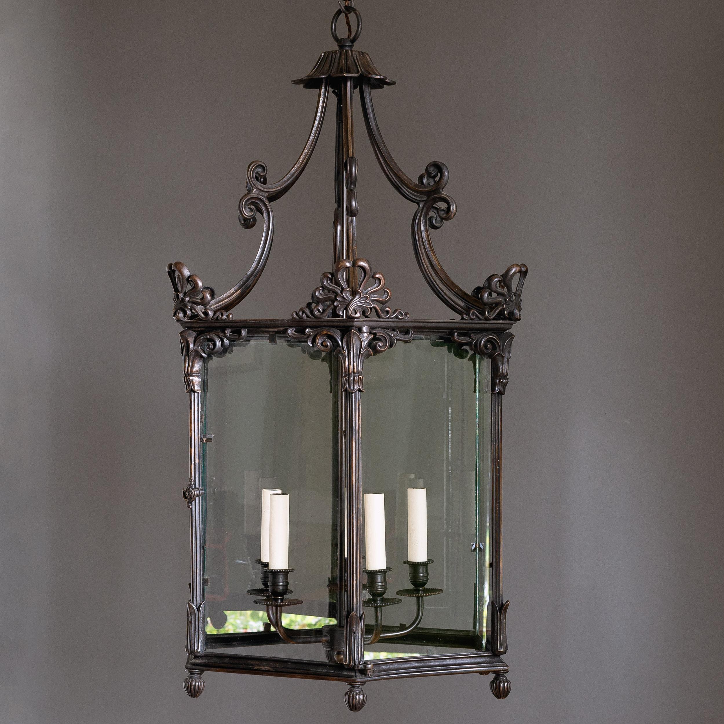 A large bronzed hallway lantern with anthemion mounts, c.2000. A substantial and boldly conceived Regency style glazed lantern with five light suspended chandelier within. Re-wired and PAT tested.