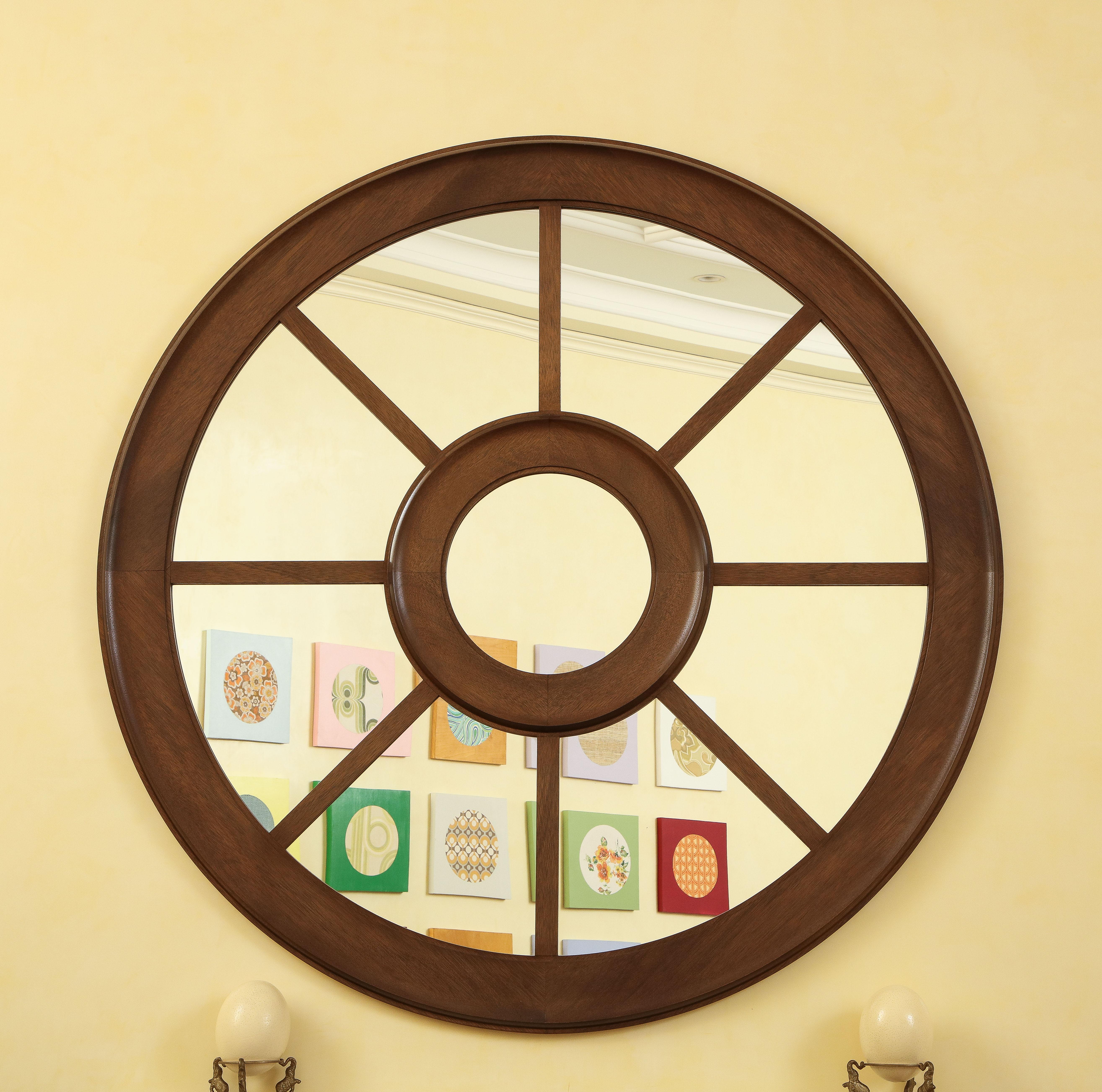 Grand, large-scale circular wall mirror with sections in wagon wheel design.