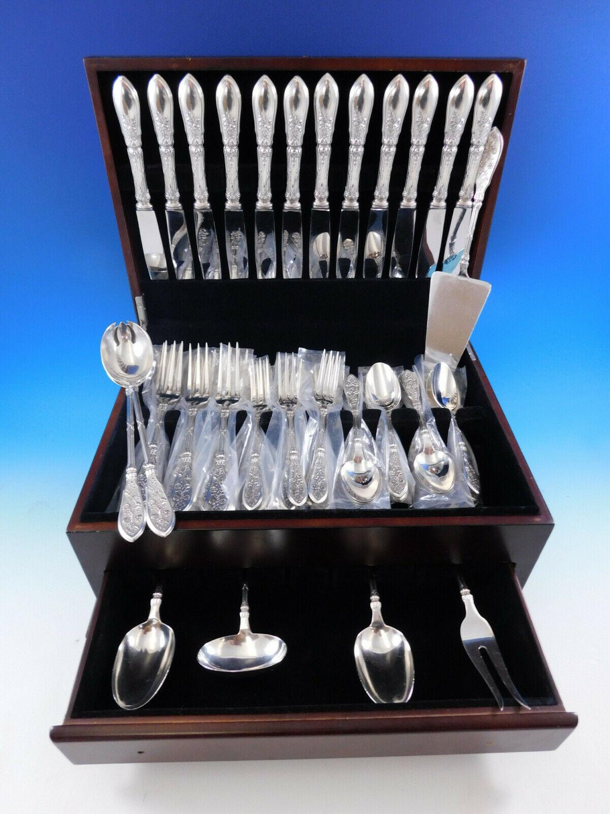 Exceptional dinner size French silver set in a design of flowing ribbon, bows, and flowers. Grand Cru by Henin & Cie sterling silver flatware set - 55 pieces. This set includes: 

12 dinner size knives, 10 1/8