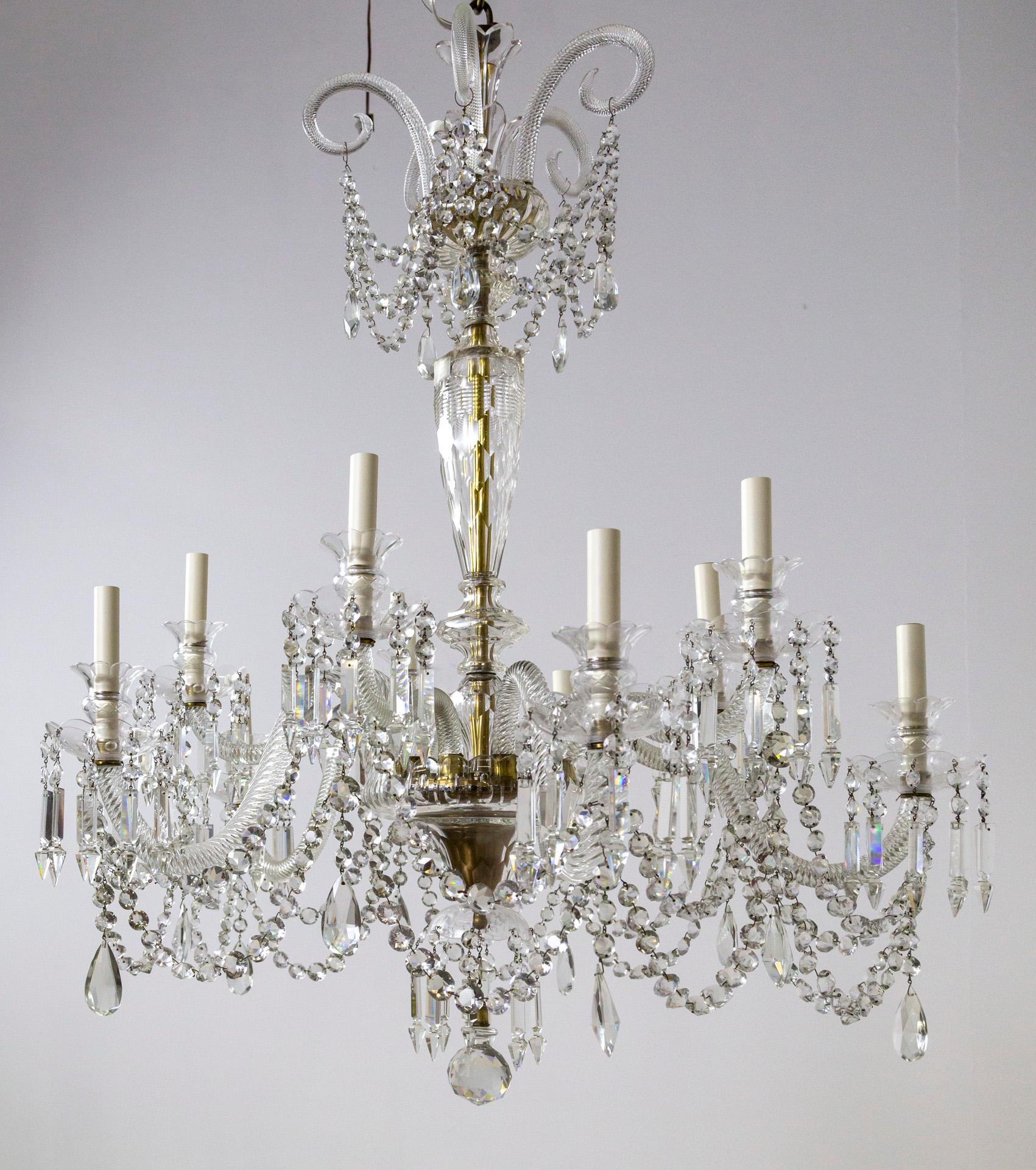 An exceptional Georgian style leaded crystal chandelier with 10 arms and four-foot length.  It was made in the UK in the early 20th century.  It has a complex, elegant design; a unique column with cut crystal 
