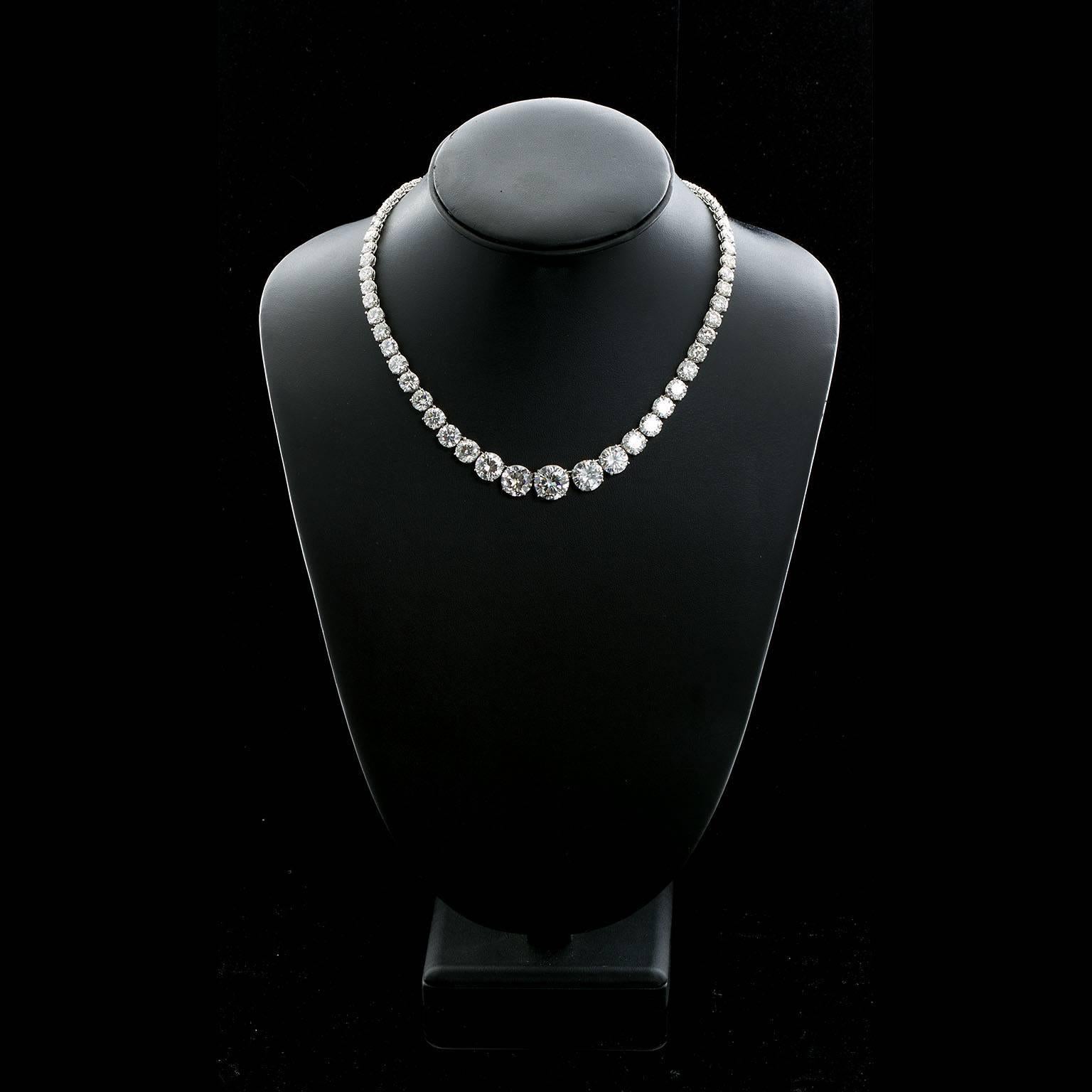 A diamond in platinum Rivière style necklace comprised of articulating links four-prong set with graduated round brilliant cut diamonds. The largest diamond is a 3.01 ct. J color VS1 clarity, then two four carat diamonds of similar color and clarity
