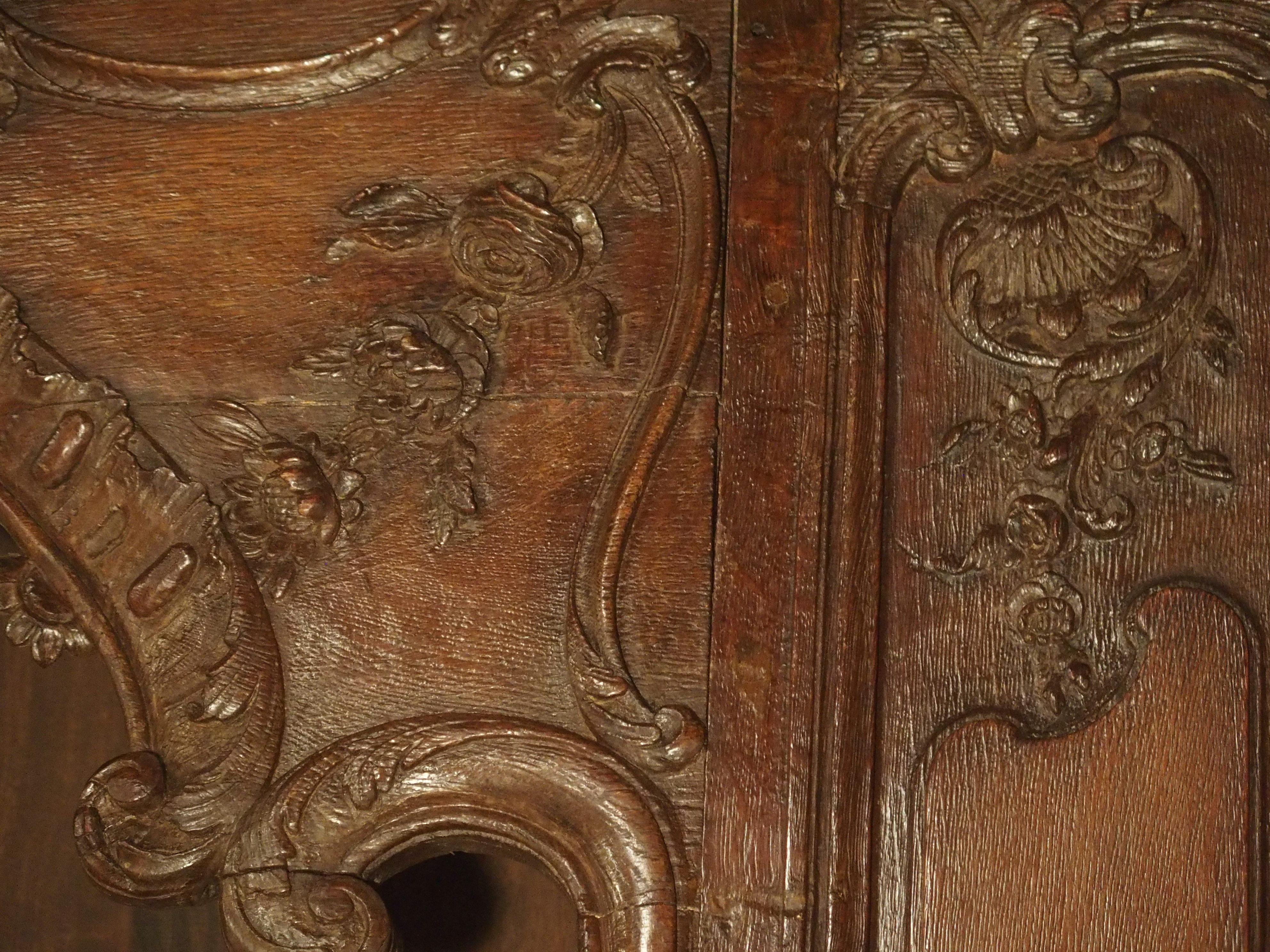 This absolutely stunning bookcase was constructed from a period French door surround, circa 1715. The frontage, crown, and sides are original and were delicately carved out of French oak. The large door surround would have been a part of a boiserie