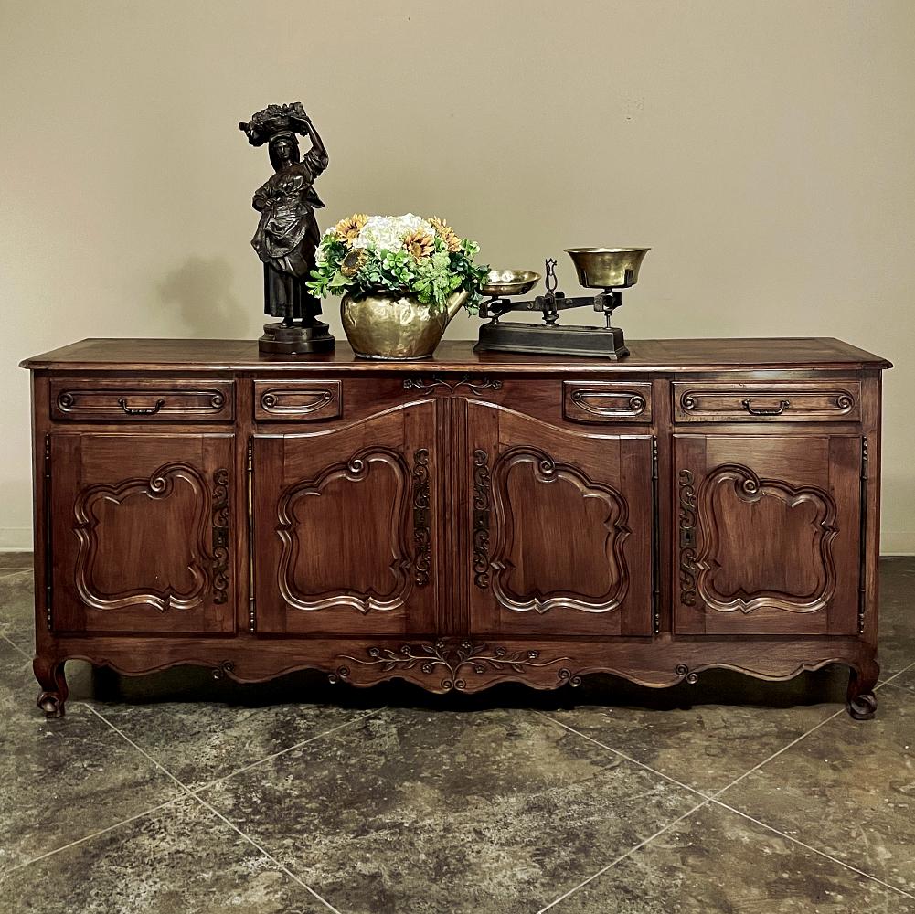 Grand early 19th century country French cherry wood buffet is a magnificent example of hand-crafted tradition! Created on a large scale using indigenous old-growth cherry harvested from trees that no longer bore fruit, its color and grain are truly
