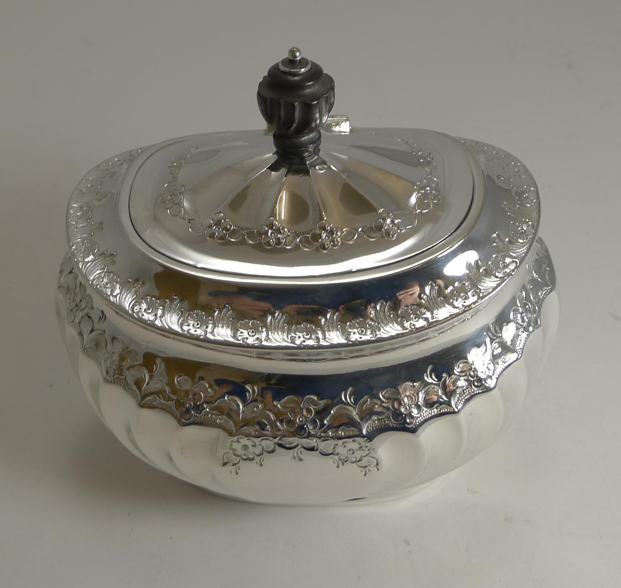 A fabulous large English tea caddy made from English silver plate by the top-notch silversmith, Atkin Brothers fully marked on the underside.

The beautifully shaped body has an attractive embossed and engraved decoration and the hinged lid is