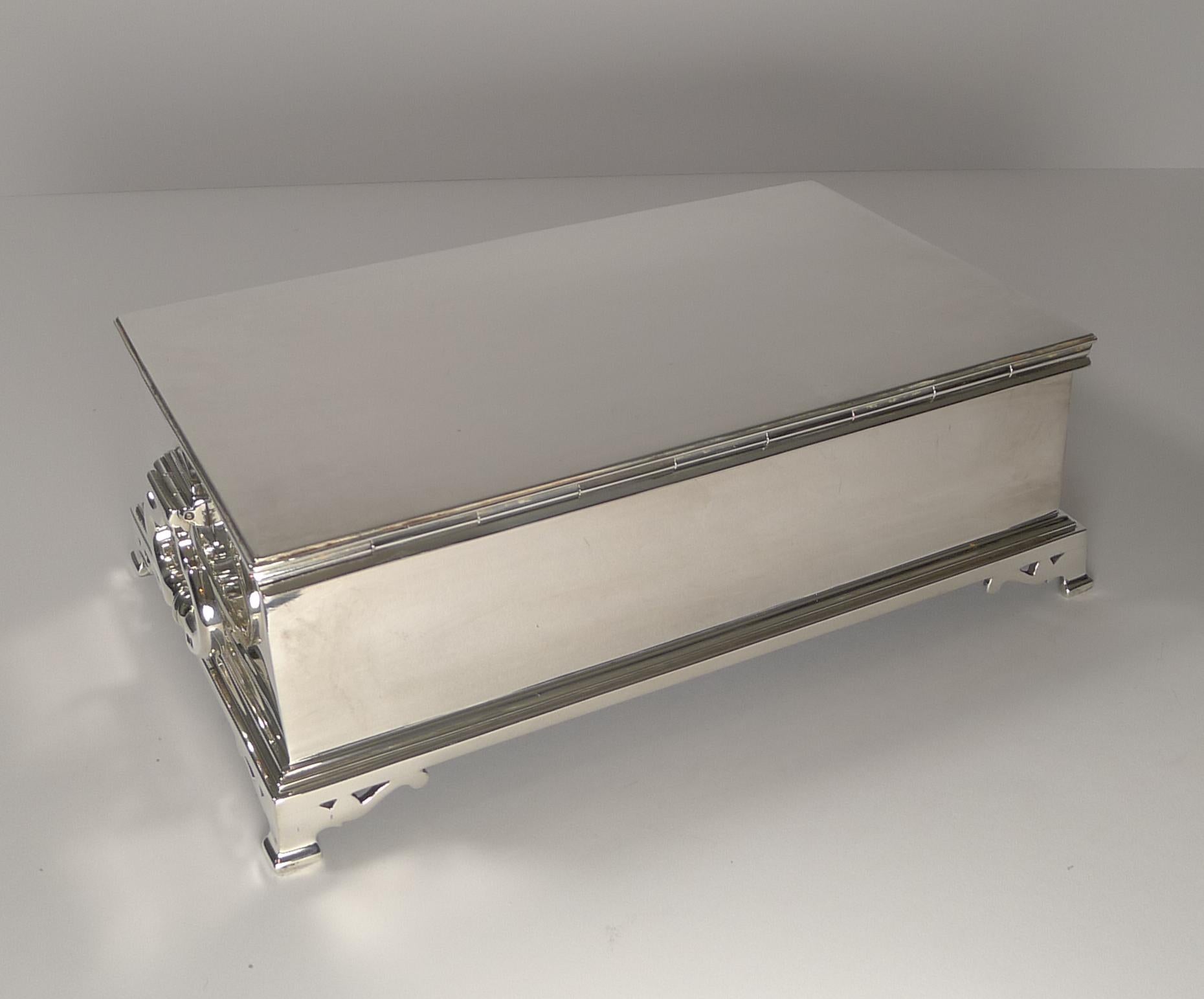 A top quality cigar box made from English solid or sterling silver, a heavy box with good gauge silver with solid cast bracket feet and the most fabulous two hinged handles to either side, both separately hallmarked.

When the lid is lifted, you