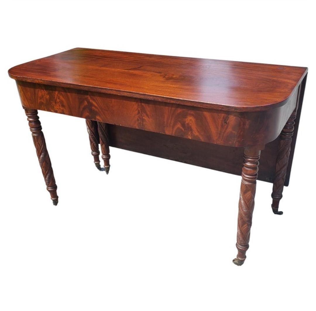 For your consideration is this Grand Federal / Hepplewhite Ribbon Mahogany Three-Part Dining Table dating from the early 1800s. This table of extraordinary width uses double hung leaves to its fullest length to create its size. The heavy leaves are