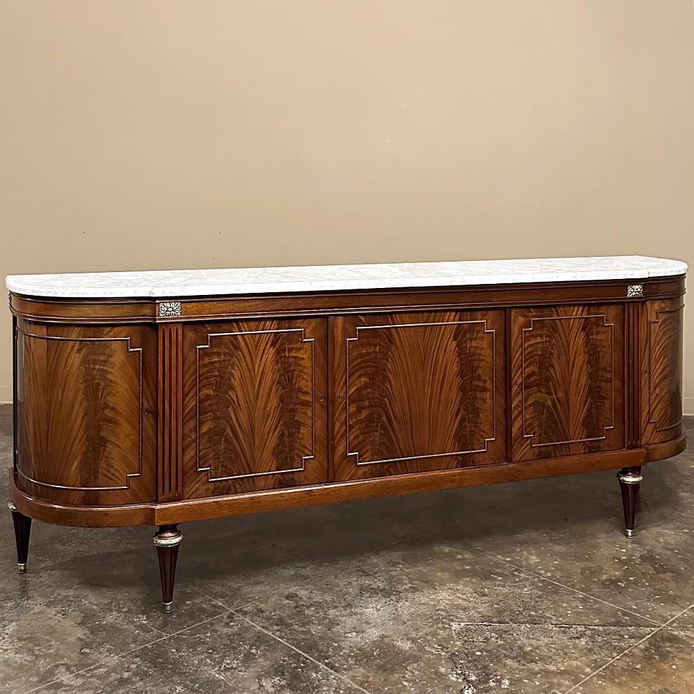 Grand French Louis XVI Flame Mahogany Buffet with Carrara Marble represents the epitome of restrained elegance crafted on a larger scale than usual.  Stretching over eight and a half feet in width, it is topped with luxuriously veined Carrara marble
