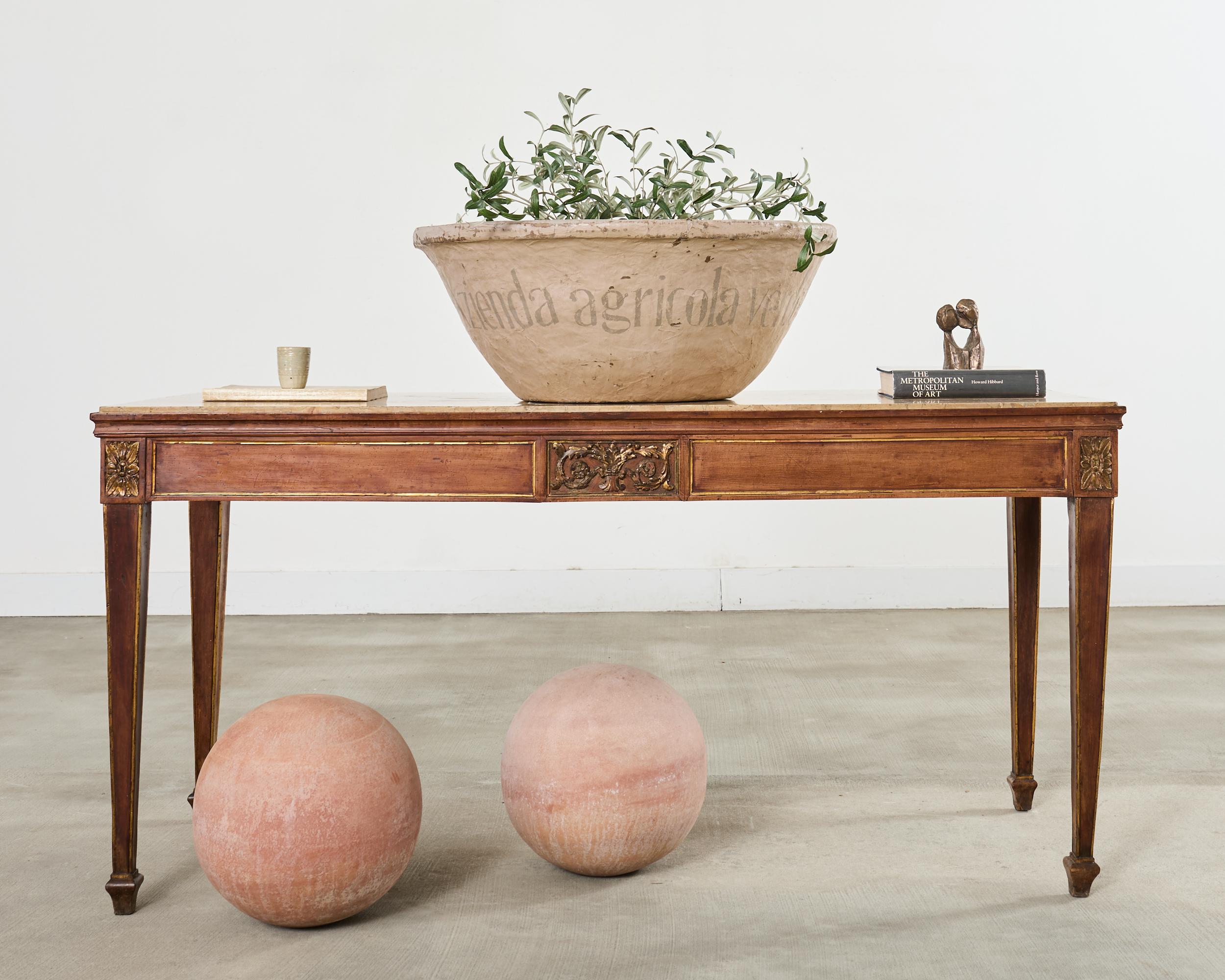 Opulent 19th century French walnut library table or console table made on a grand scale. The table features a carved walnut frame crafted in the Louis XVI neoclassical taste with Napoleonic empire design inspiration. The frame is thick, heavy, and