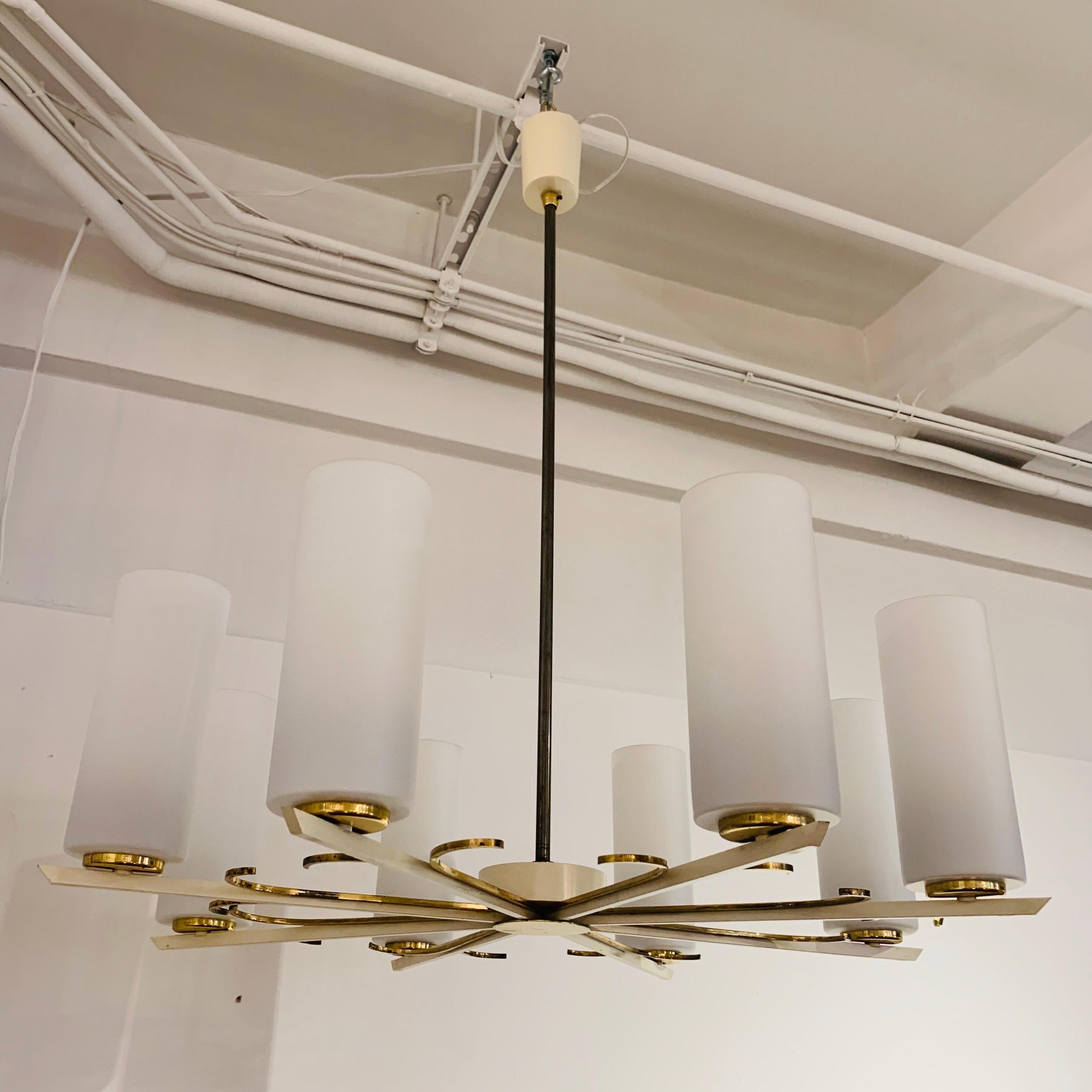 A grand 1950s polished brass and white enamel chandelier with white glass shades. Made by the German maker, Kaiser Leuchten. Rewired.