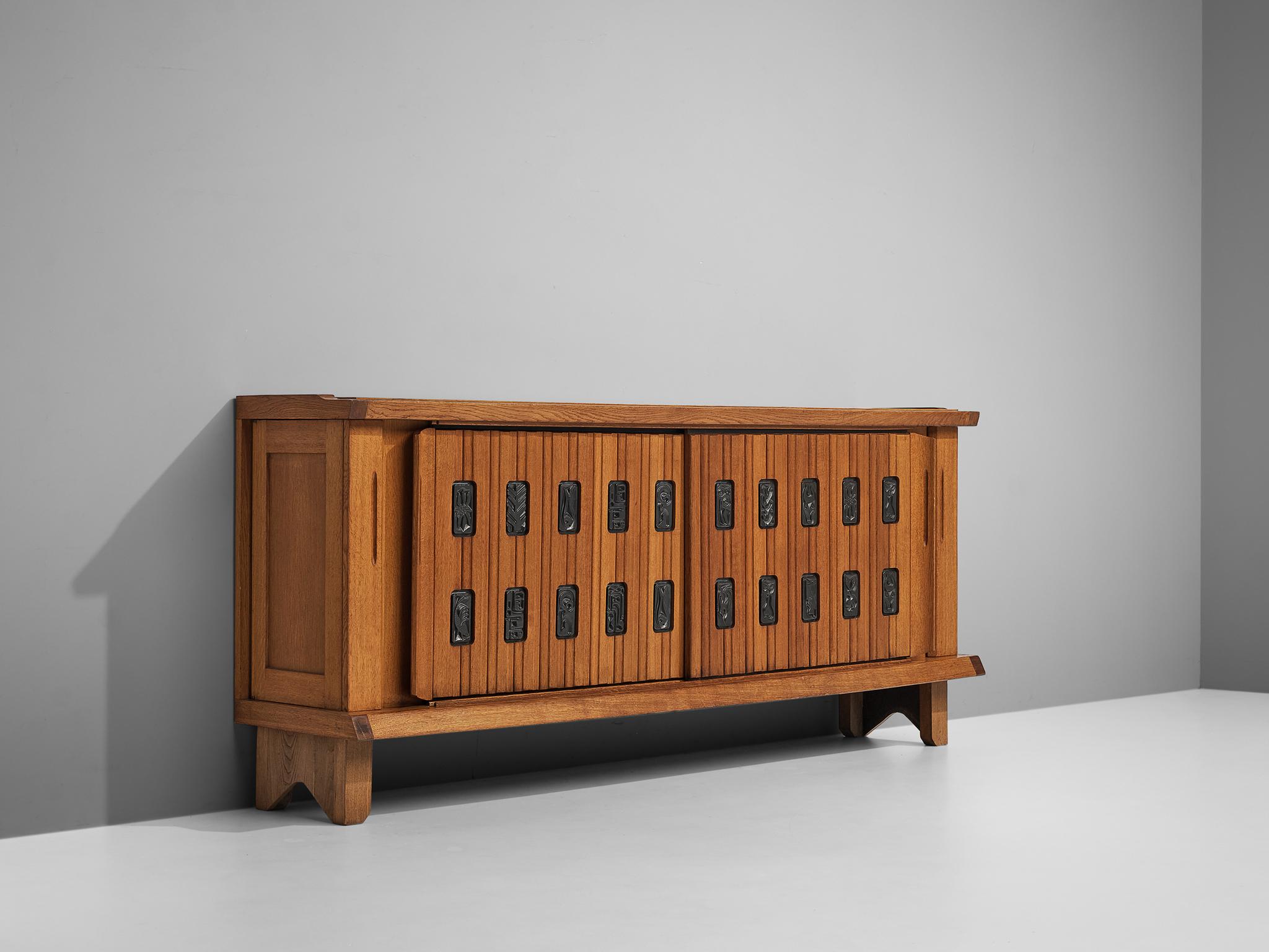 Guillerme et Chambron, sideboard, solid oak, ceramic tiles, France, 1950s

This cabinet holds the characteristics of the French designer duo Guillerme & Chambron. The base has typical legs and provides a floating appearance to the storage part.