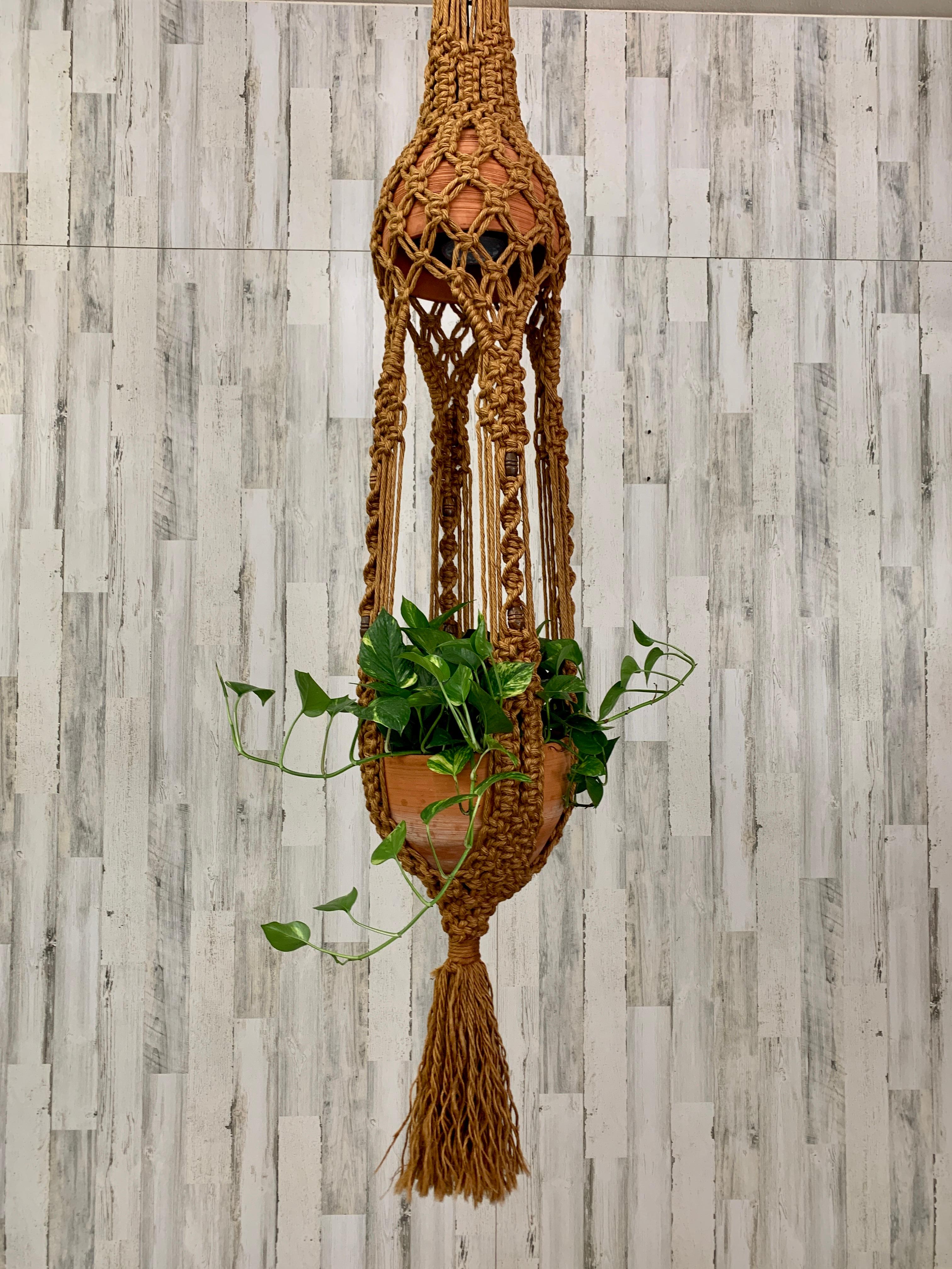 Vintage oversized complex design hand woven Jute with wood beads hanging macrame Lamp. This sculpture has opposing terra cotta pottery one for the lamp shade and one for the plant.