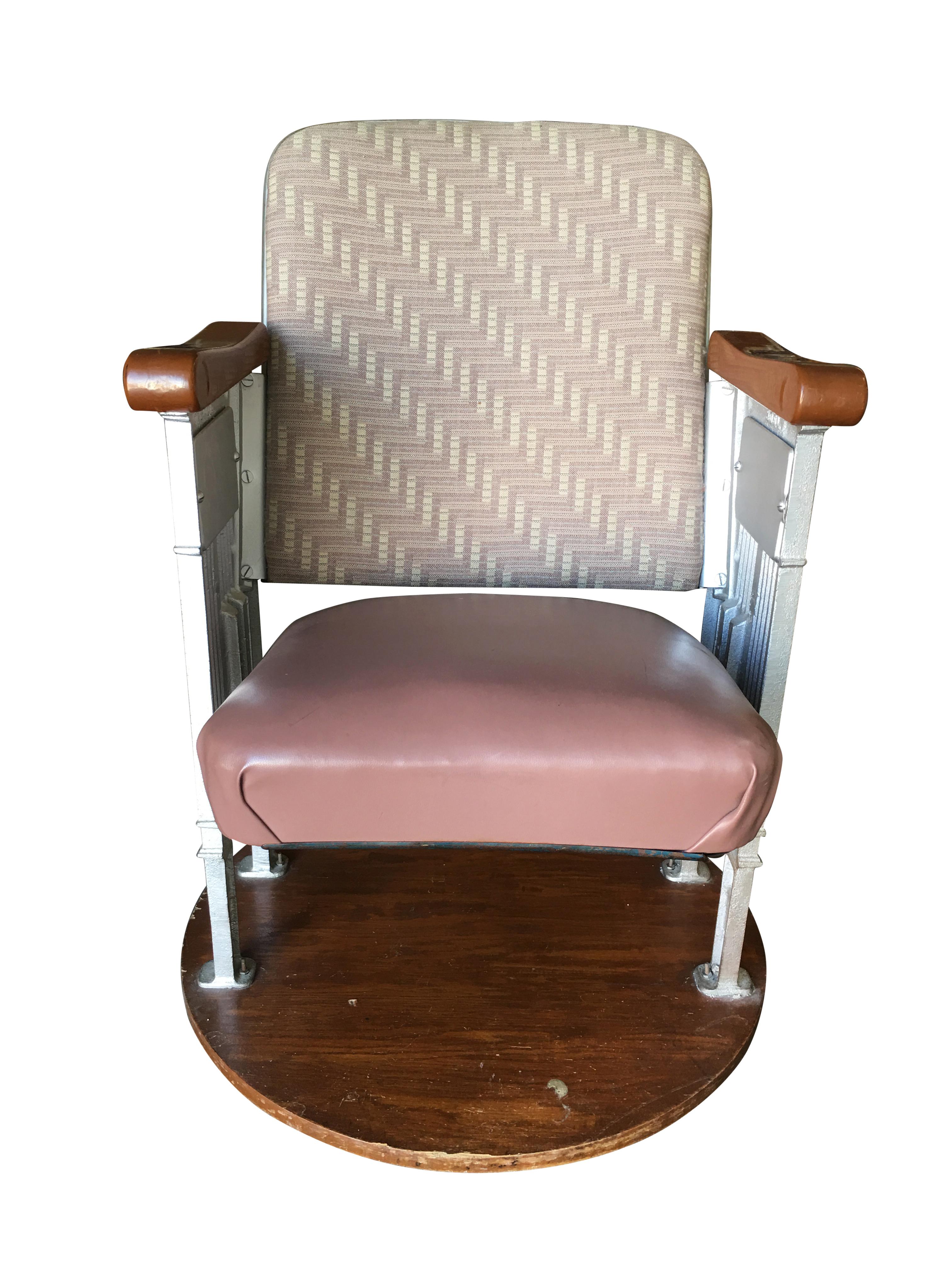 Art Deco movie Theater chair featuring casted iron frame with sculpted wood arms from a Hollywood movie theater. The chair originally floor mounted has been fixed to finished wood base.

Two chairs available,
circa 1920.