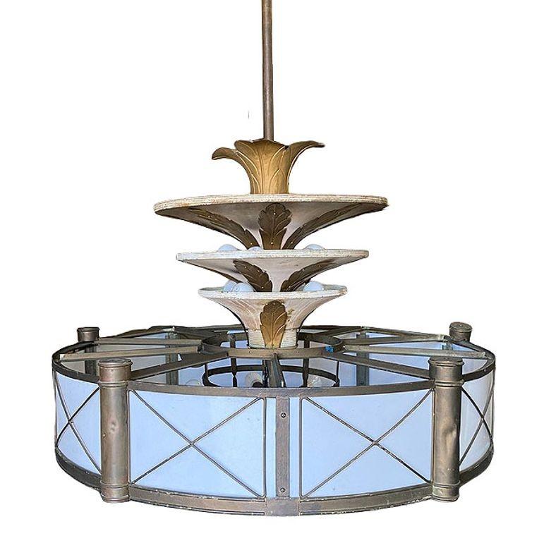 This stunning, large-scale chandelier was custom-made for The Ambassador Hotel's Coconut Grove nightclub. It is composed of interlacing brass palm leaves, frosted plate glass sides, and 3 tier stepped neck.

Three small chandeliers available.

The