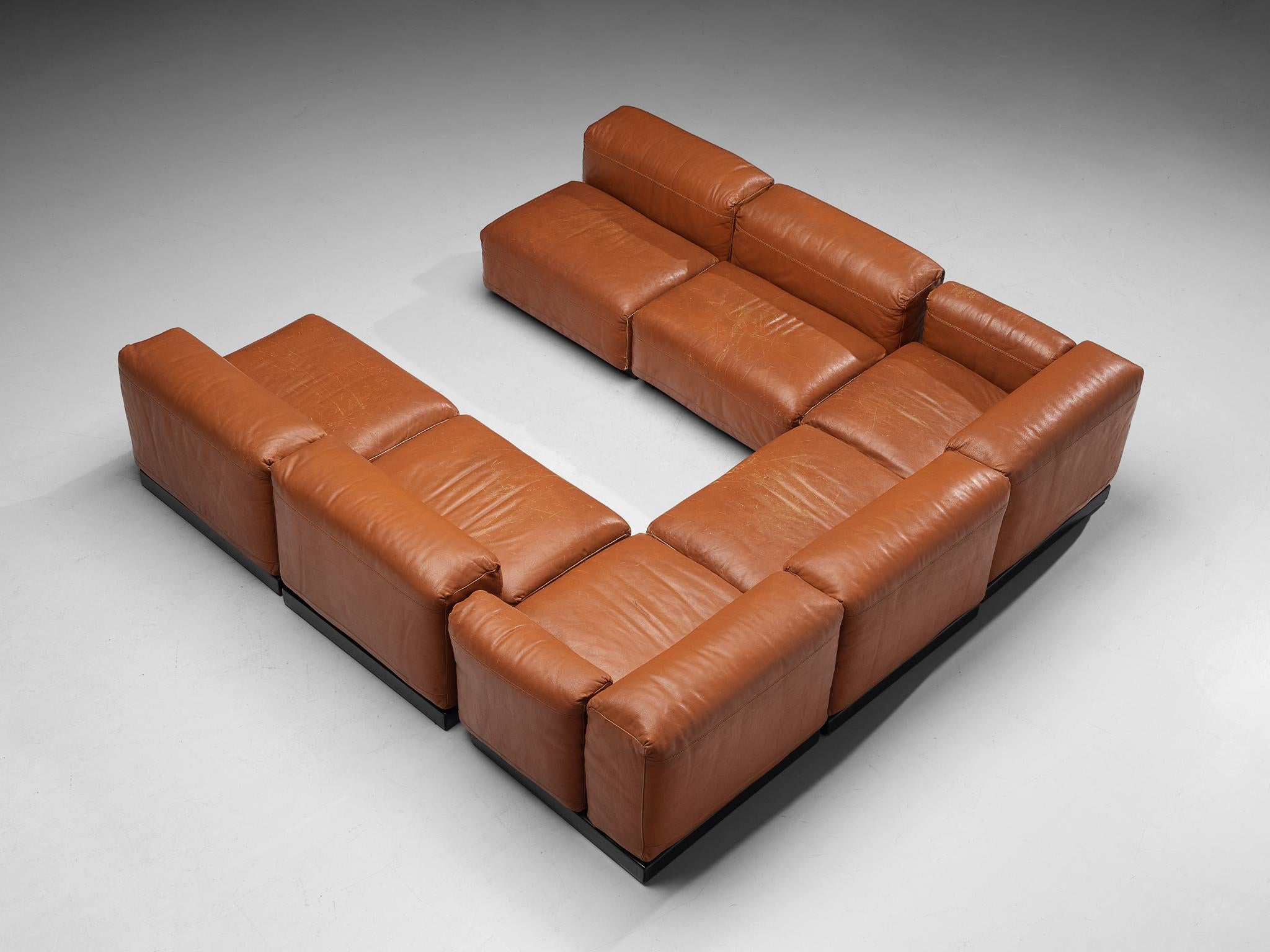 Sectional sofa, leather, wood, Italy, 1970s 

This well-designed sofa is fully executed in beautiful cognac leather that contributes to the whole unit’s monochrome look. This sofa is characterized by a splendid construction consisting of five