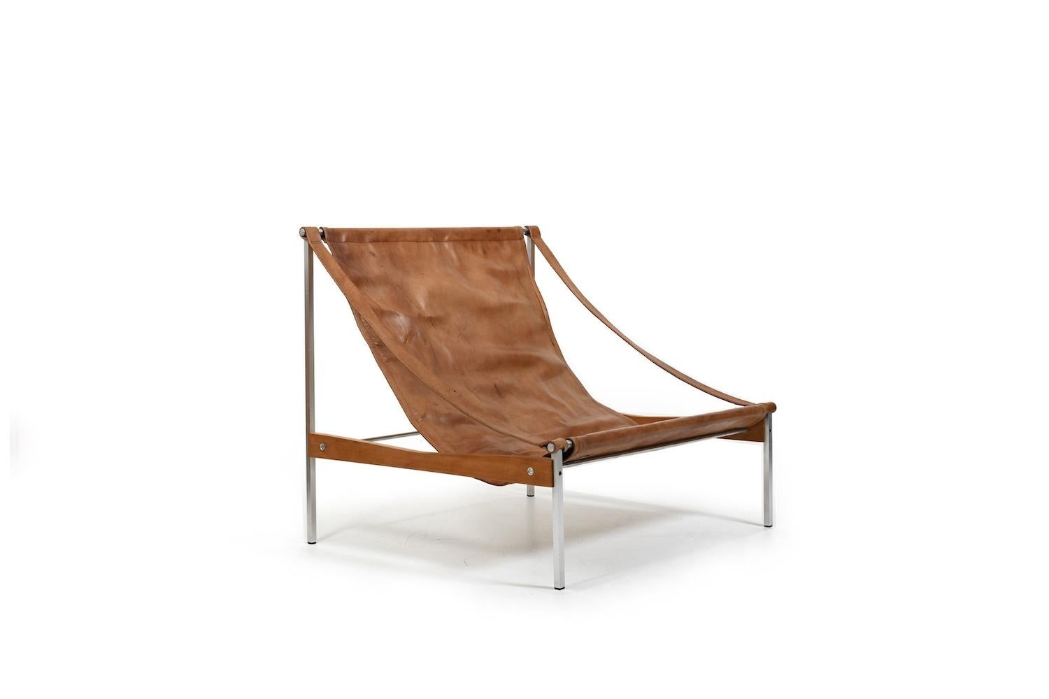 Rare grand leather and steel chair „Bequem“ by Stig Poulssen, Denmark 1970s. Patinated brown leather and pine wood. Very nice vintage condition. We can send it dismanteled, so its cheaper to ship with DHL
