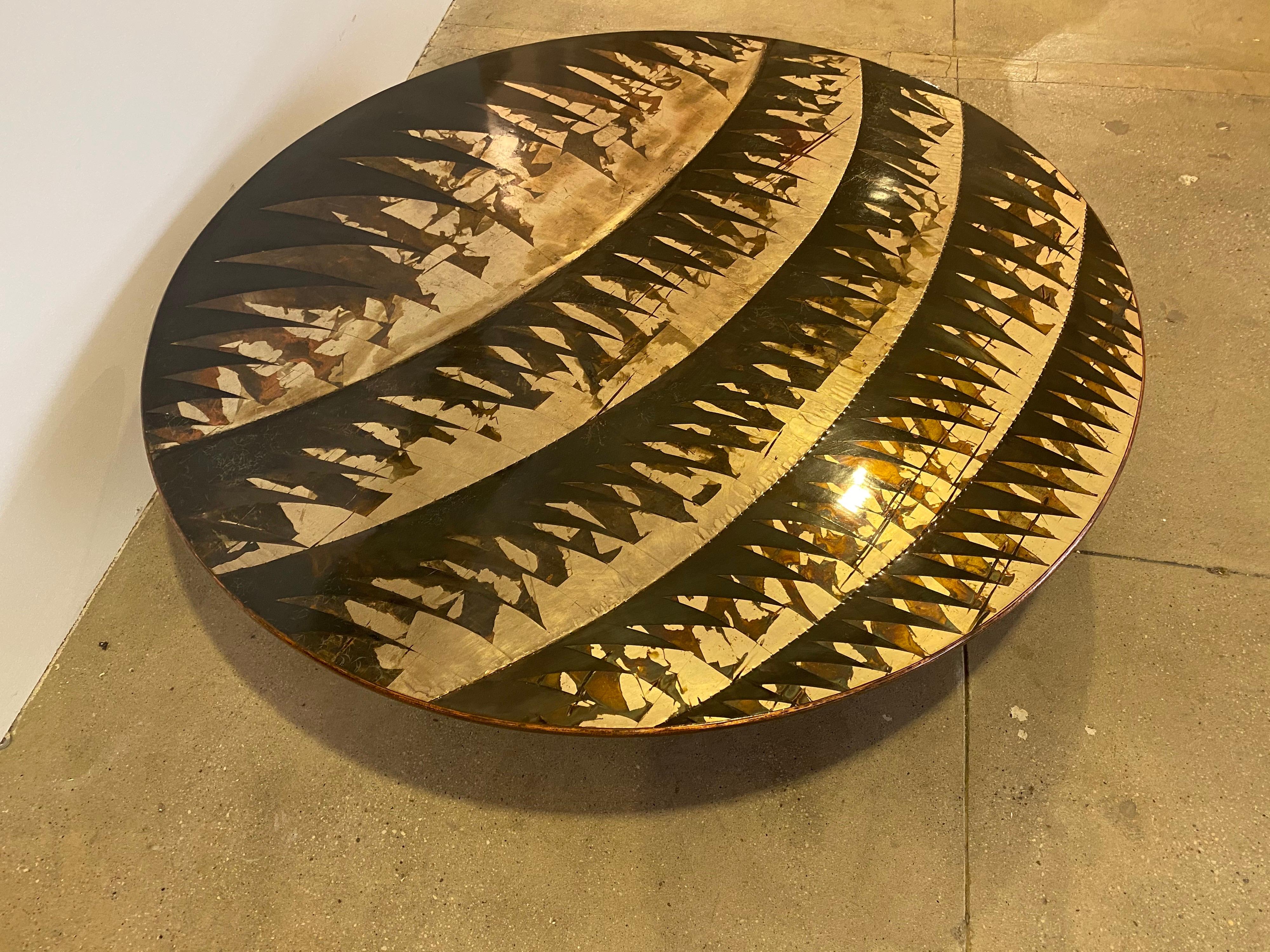 A large 58” wide round sculptural handcrafted silver and bronze coffee table by famed Italian artist, Lorenzo Burchiellardo. Signed, circa 1972. The table is composed or etched and patinated decorated stripes of silver and bronze. The table is in