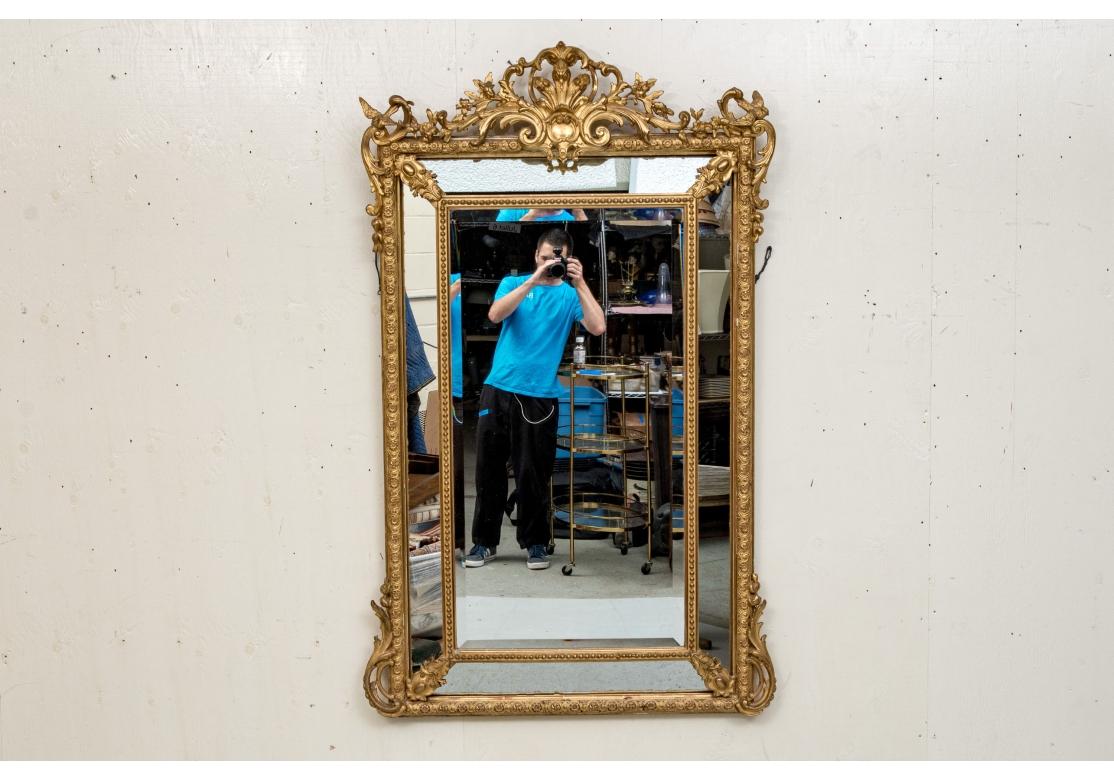 A Louis XVI style gilt wood mirror with a 1