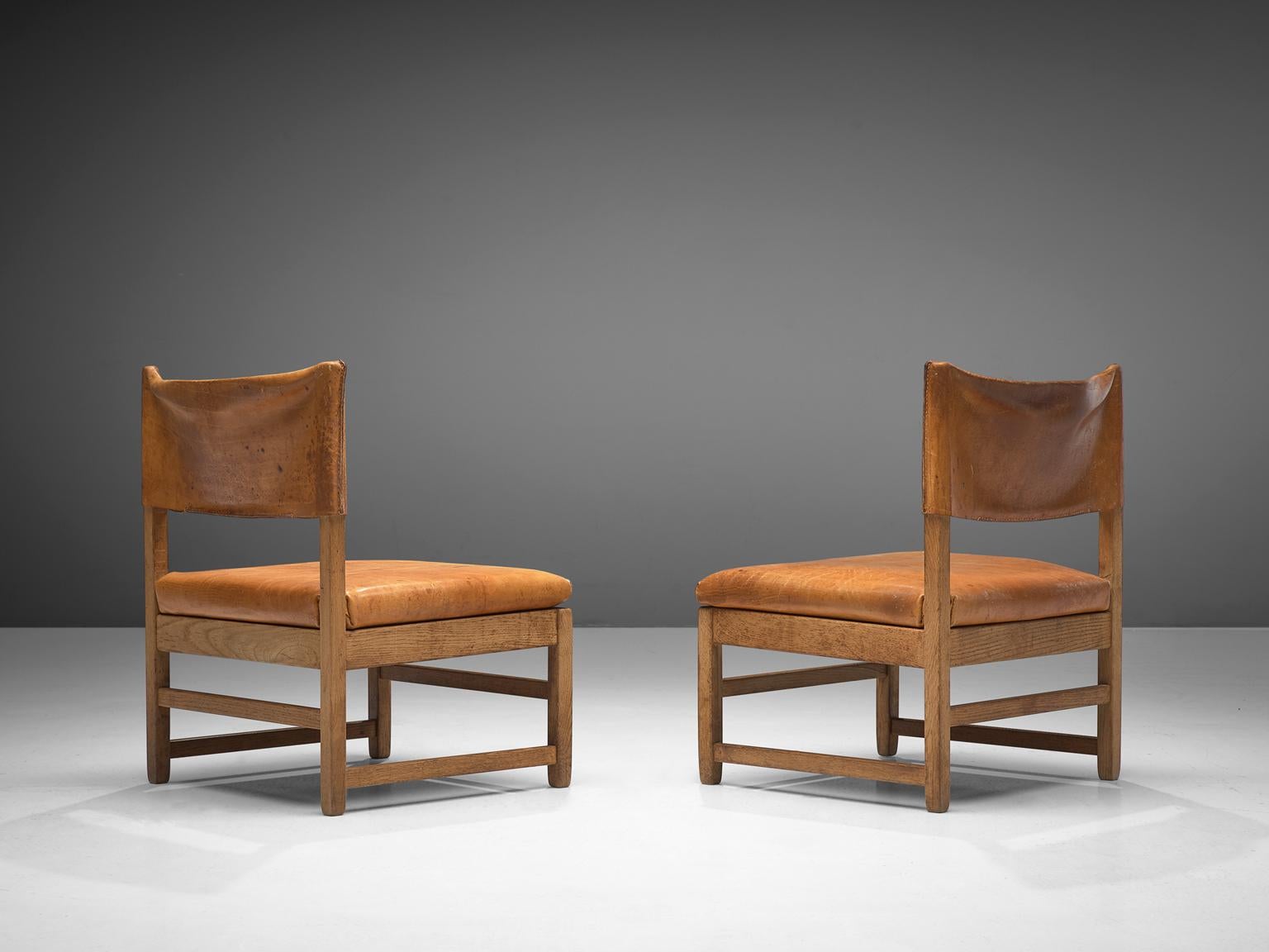 Grand lounge chairs, oak and cognac leather, France, 1960s

Wonderful set of two lounge chairs is designed in Scandinavia, made in solid oak are upholstered with cognac saddle leather. This set has a wonderful rich patina that makes this set