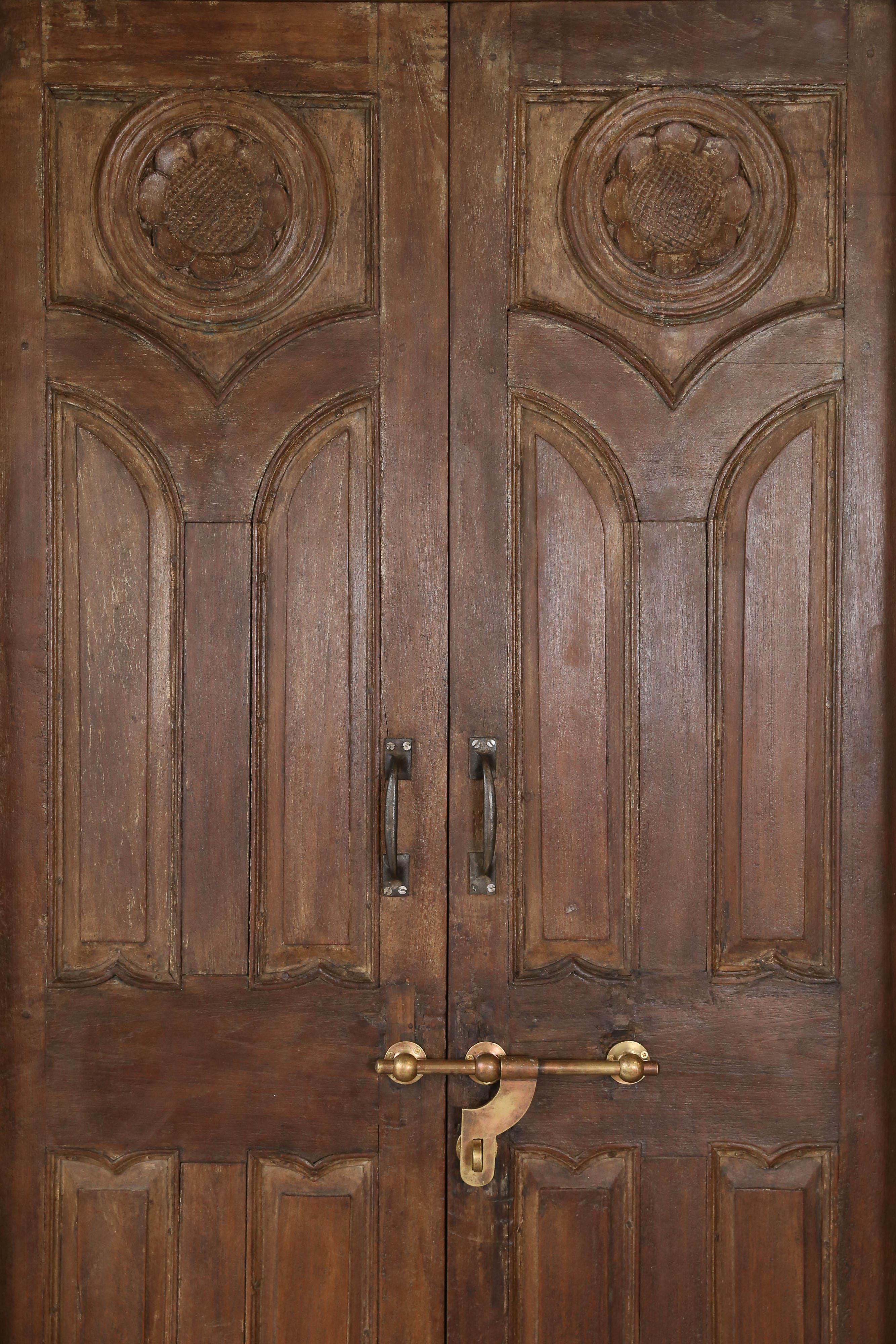 This door comes from a custom built mansion of an European settler in Central India This door unlike other doors made at that times is finished both outside and inside. Made of solid teak wood this door will survive several more decades. It retains