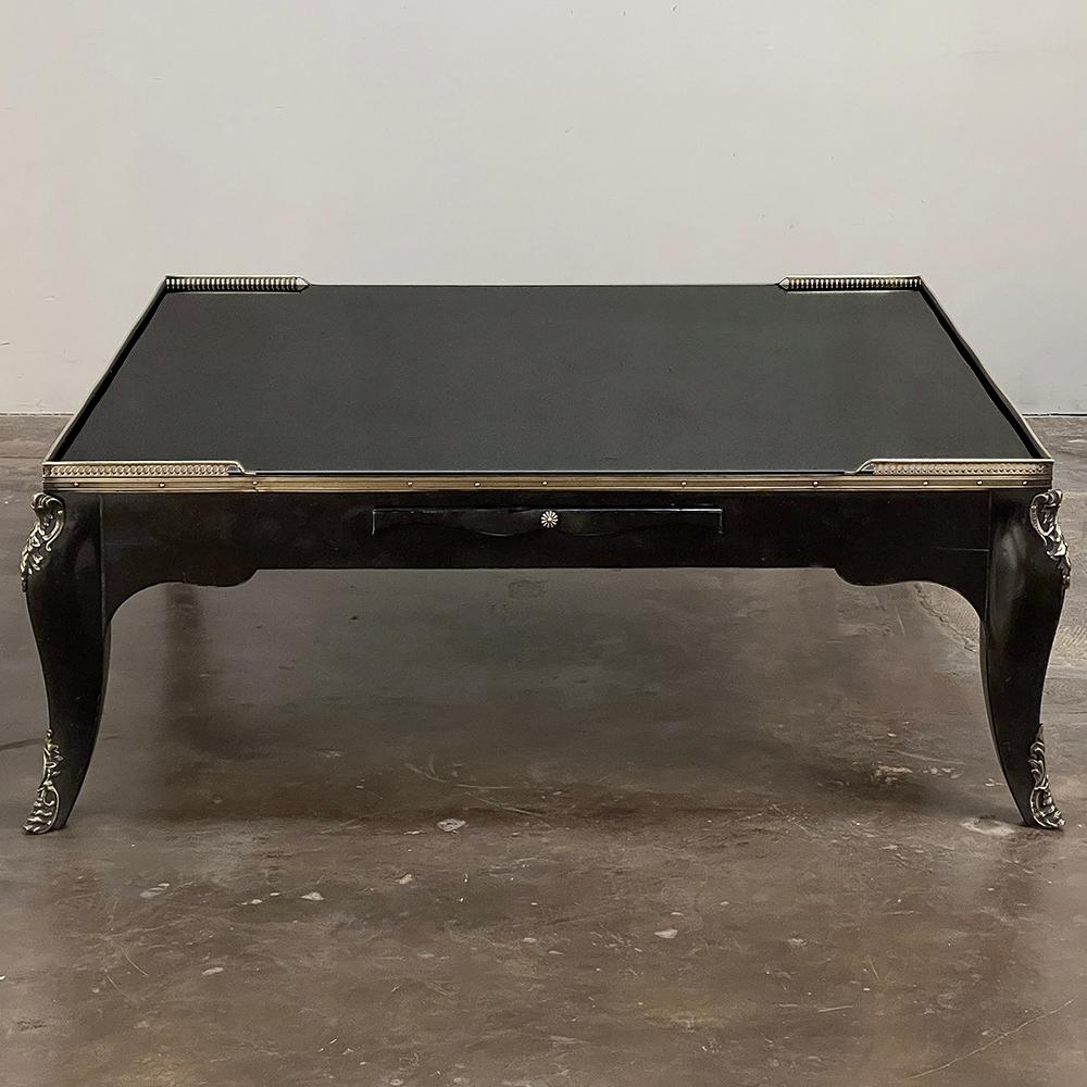 Grand Mid-Century French Black Enamel Coffee Table with Glass Top is perfect for a large family room!  Square in shape, it features a 2400 square inch glass top surface for carefree entertaining and daily use.  The glass is held in place by a solid