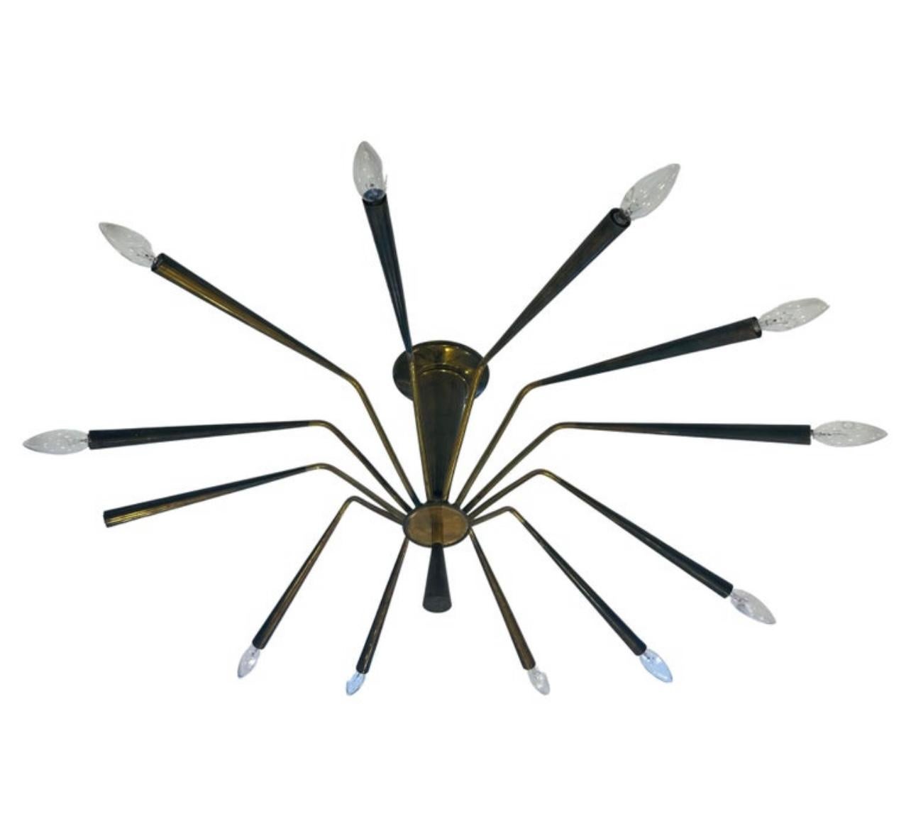 A large 1960s aged brass spider chandelier with 12 sockets designed by Oscar Torlasco for Lumi. 1960. Rewired.