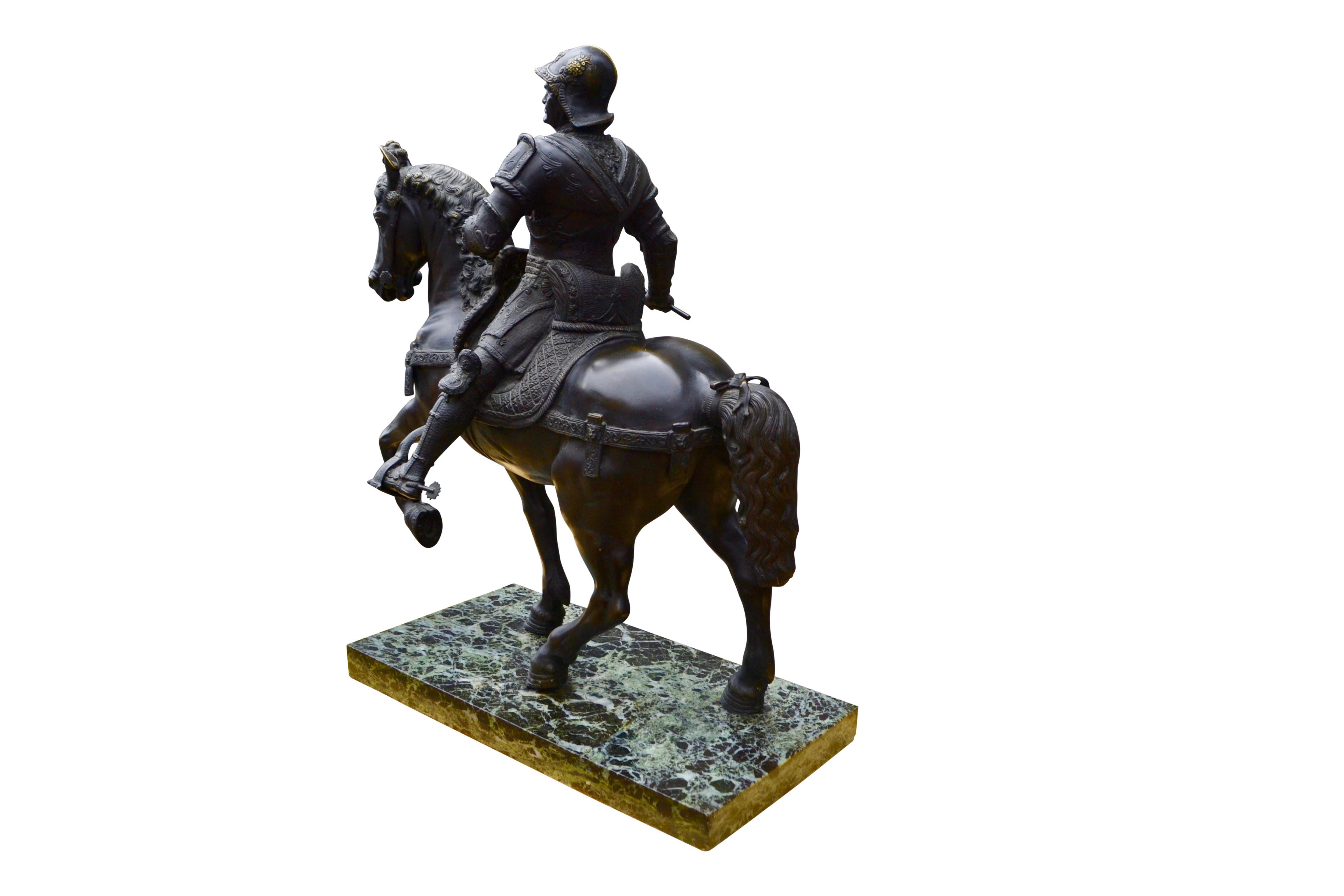 A very finely cast late 19 century Grand Tour bronze replica of the renowned statue of Bartolomeo Colleoni on horseback set on a verde antico marble base after the life sized bronze statue by the Renaissance sculptor Andrea Del Verrocchio that has