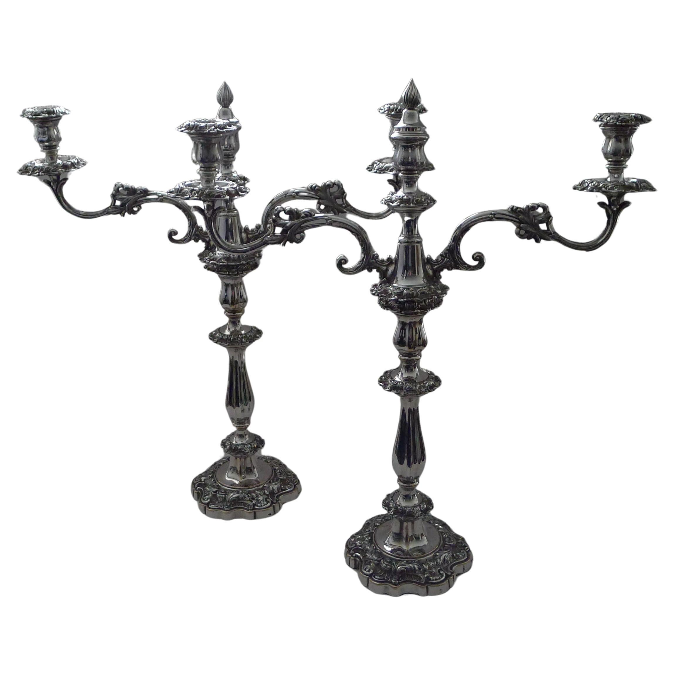 A grand pair of Regency era Old Sheffield Plate (OSP) candelabra each base marked with a cross over globe for Blagden, Hodgson & Co. of Nursery Street, Sheffield and dates to 1821.

Old Sheffield Plate is highly sought-after and collectable not to