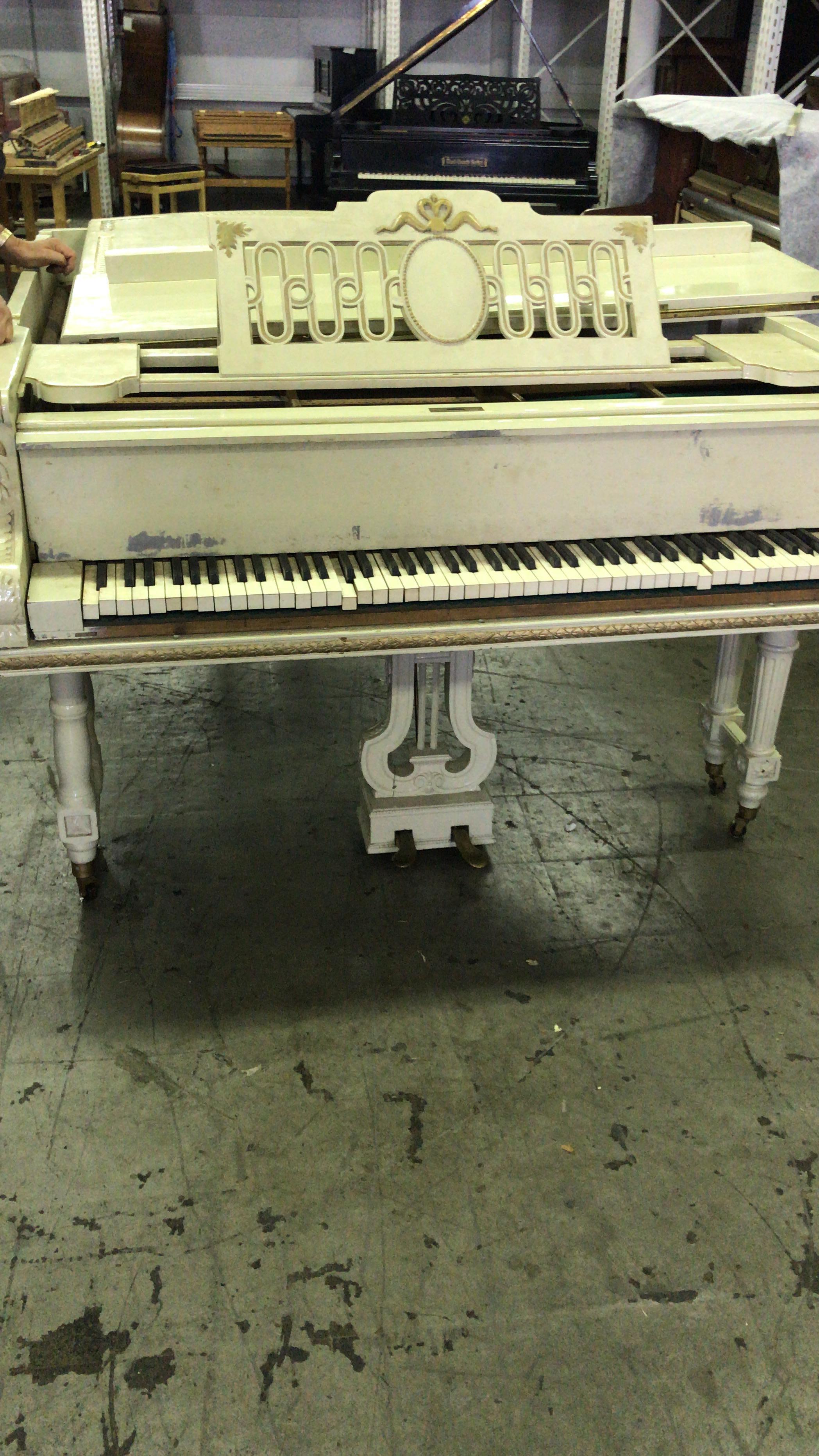 white and gold piano