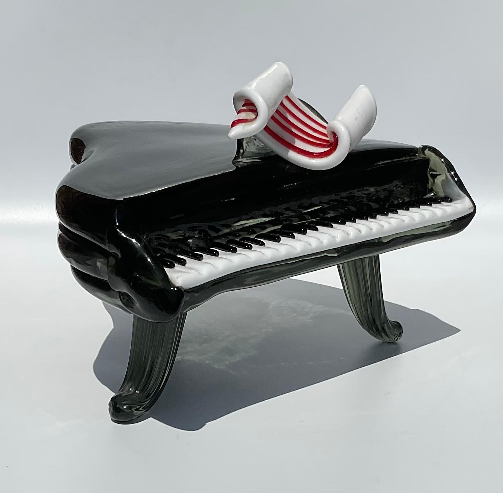 Grand Piano Sculpture in Murano Art Glass attributed to Ercole Barovier design Circa 1950’s. Amazing piano sculpture with sculpted legs, pasta glass keys, and a red and white applied ribbon. Amazing sculptural piece of glass.