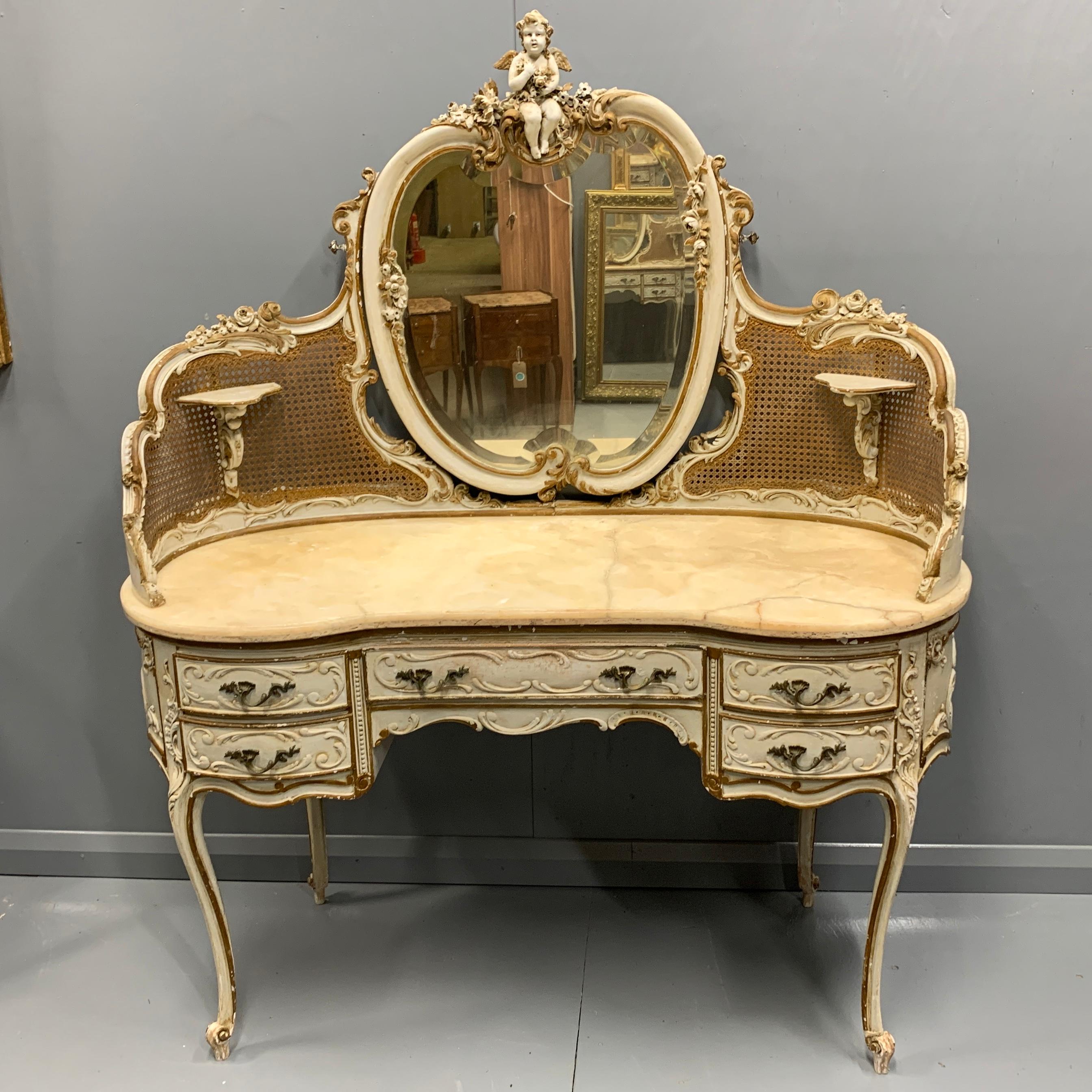 A very unusual and grand scale Italian dressing table in its original paint and bronzed gilt highlighting, original cane and bevelled mirror plate, circa 1900.
Certainly a decorative piece but also super practical, giving you plenty of surface