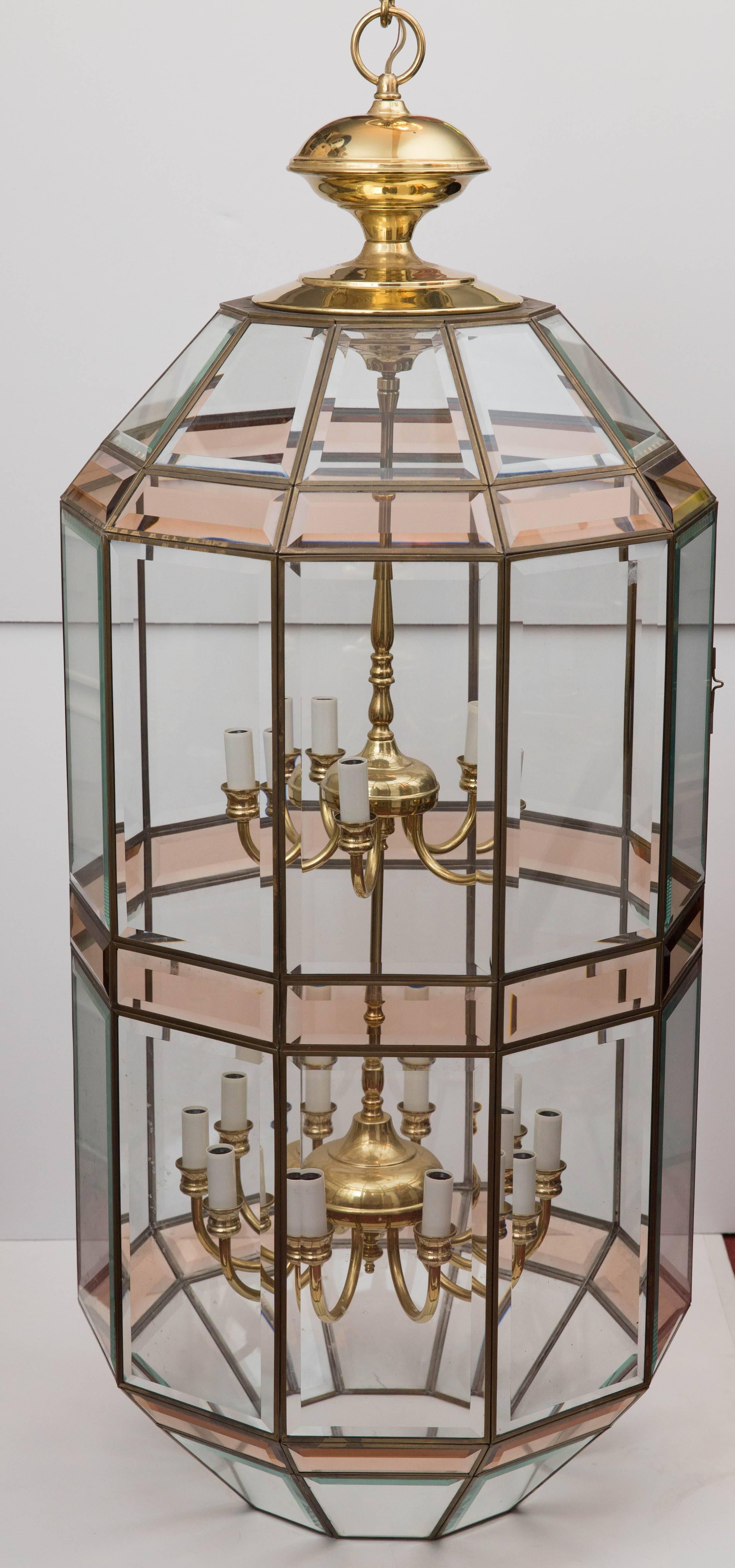 A pair of very large double-light cluster hanging lanterns. Produced by Fredrick Ramond Lighting in the 1980s. Panels of both clear and colored beveled glass surround 15 candelabra bulb sockets, five above and ten below.