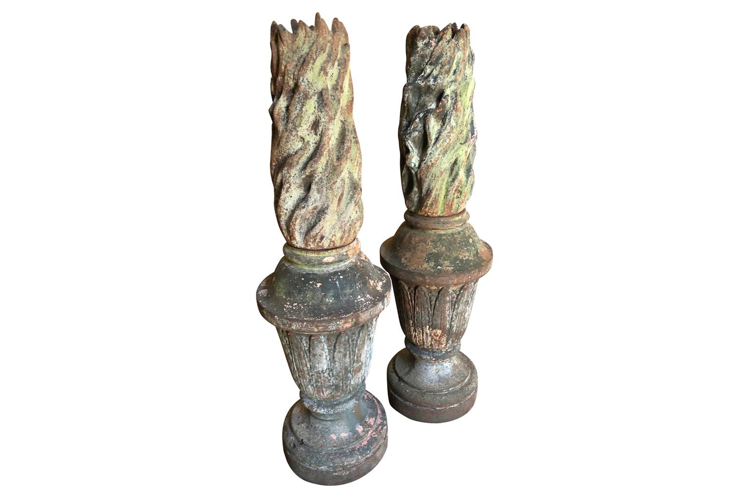 An outstanding and exceptional grand scale pair of mid-19th century French Flambeaux - Flame Finials crafted from cast iron. Extraordinary patina. Stunning for any garden or interior.