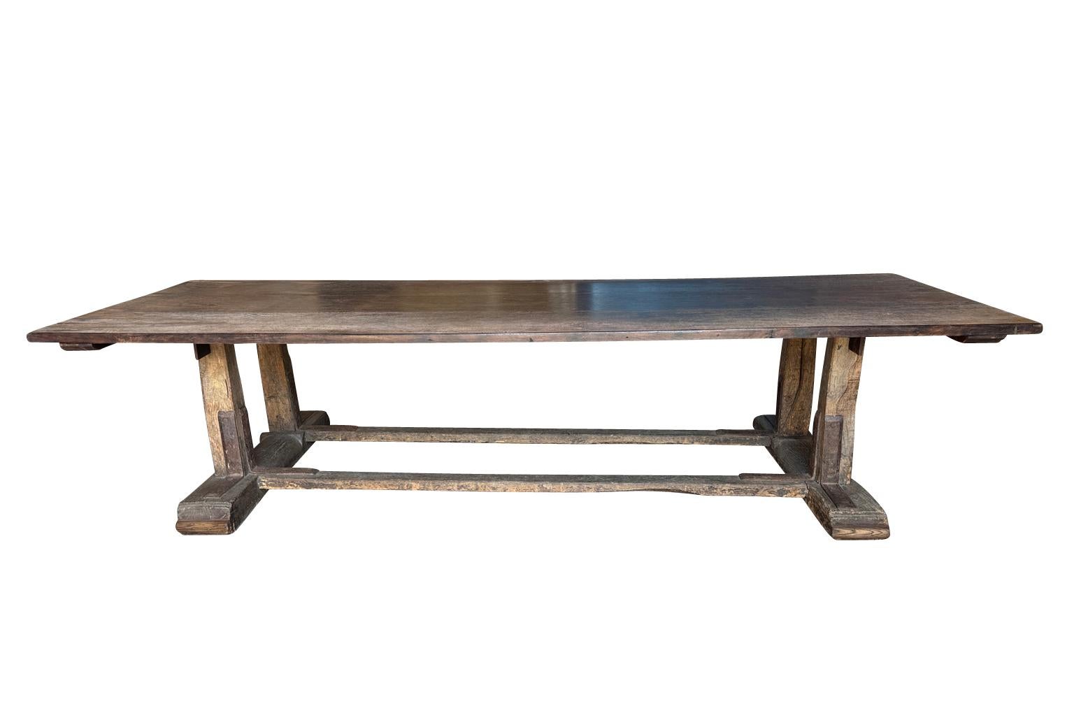 A very handsome and grand scale 18th century Farm Table from the South of France.  Wonderfully constructed from walnut and oak with handsome iron strapping to the legs and stretchers.  Wonderful for large gatherings.  Super patina.