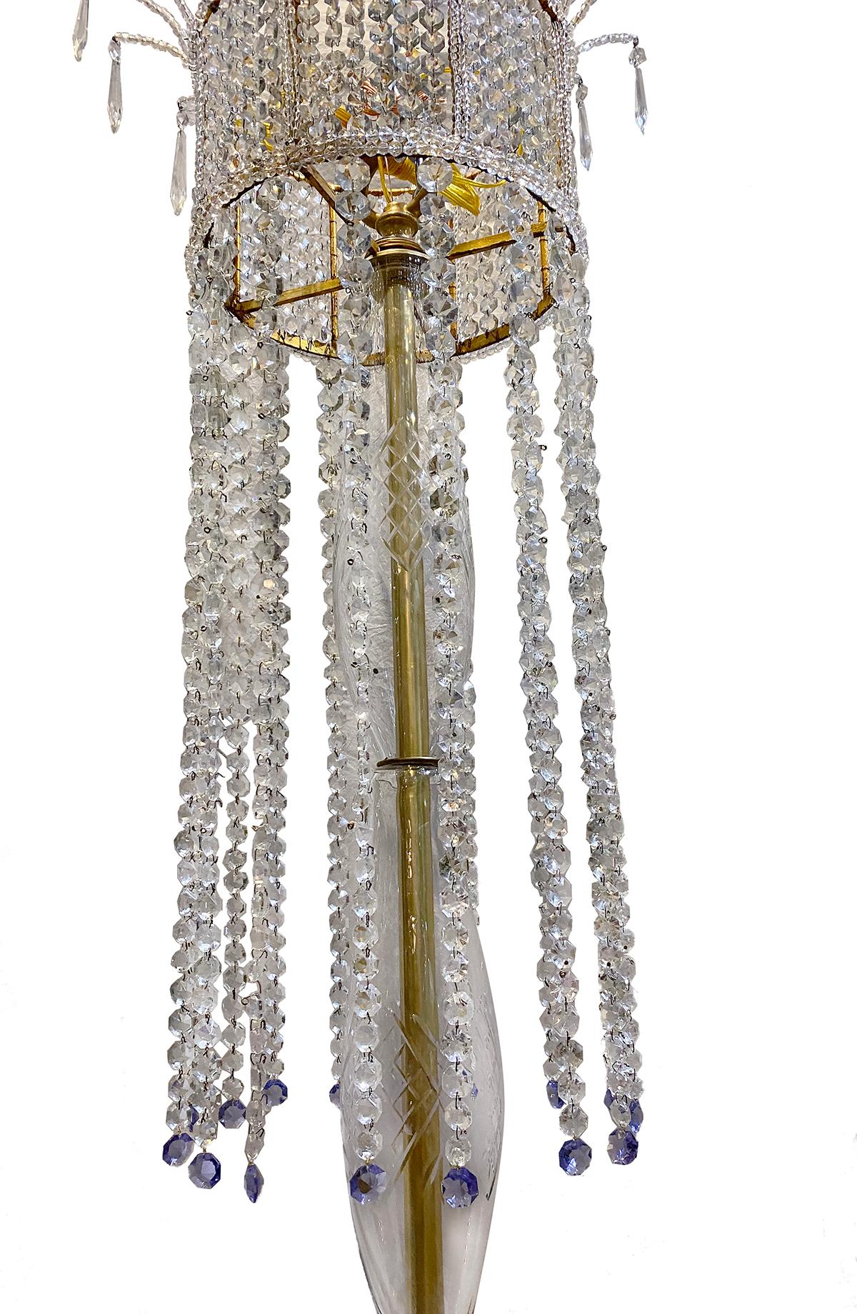 A very large French gilt metal and crystal chandelier with interior lights. The gilt metal body has beaded crystal drops and the interior lights are covered by woven crystals from the top.

Measurements:
Height 76