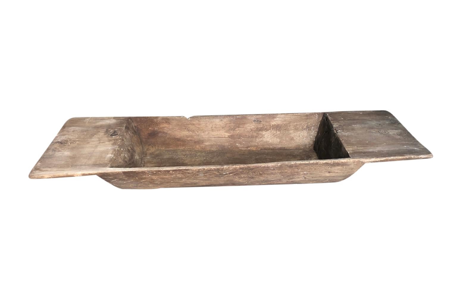 A fantastic very large scale 18th century Spanish dough bowl - or trough, carved from a single tree trunk. Perfect by a fireplace to house kindling, or filled with an assortment of candles. A terrific accent piece.