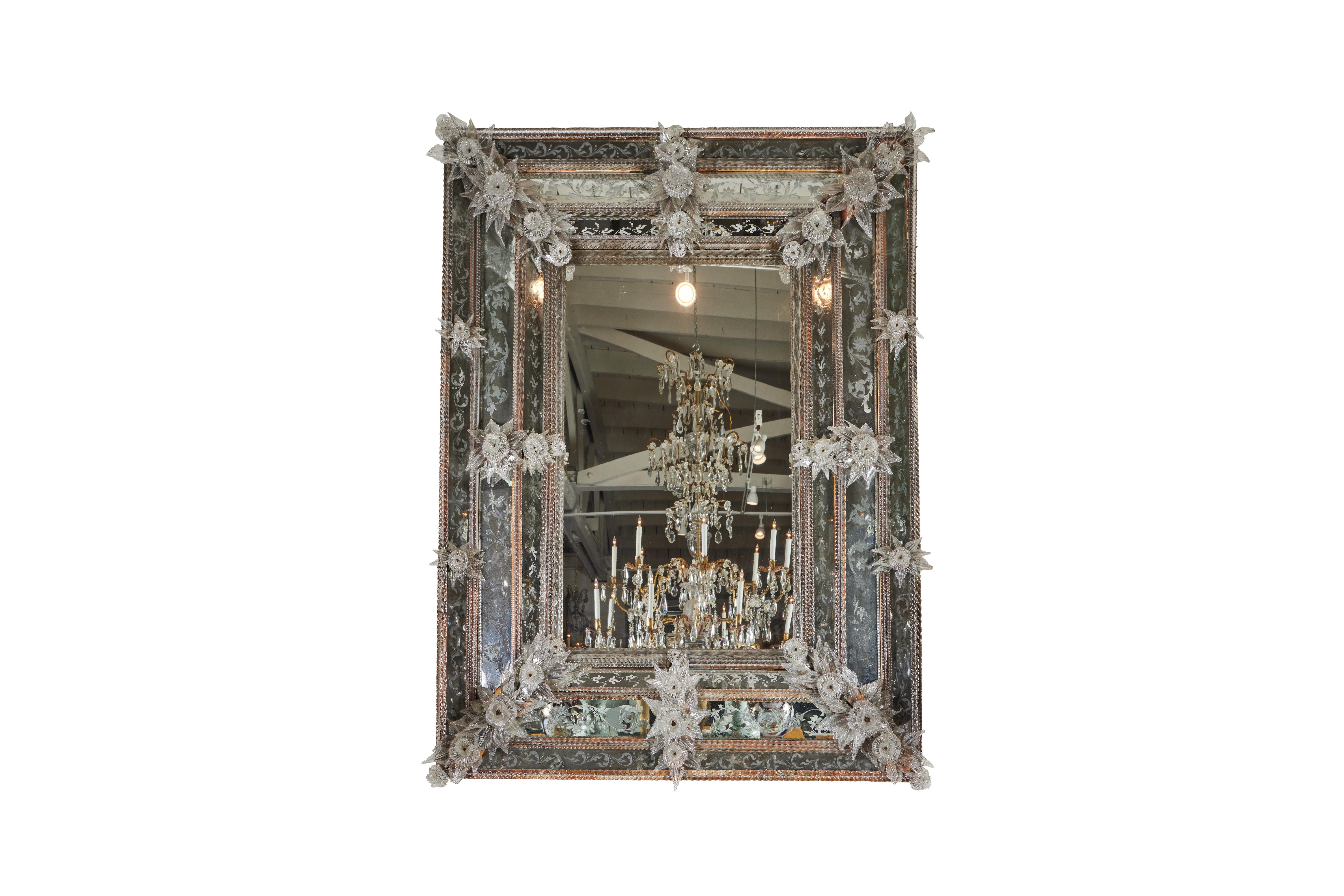 An elaborate, grand scaled, all hand blown and etched glass Venetian mirror with foliate and floral designs. From the area of Venice.