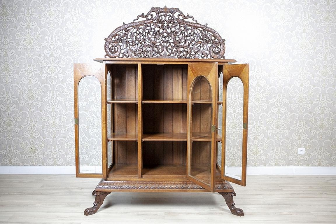 Grand Showcase from the Turn of the 19th and 20th Centuries

We present you this elaborately decorated piece of furniture from the turn of the 19th and 20th centuries.
It is composed of a three-door corpus supported on legs, which are finished with