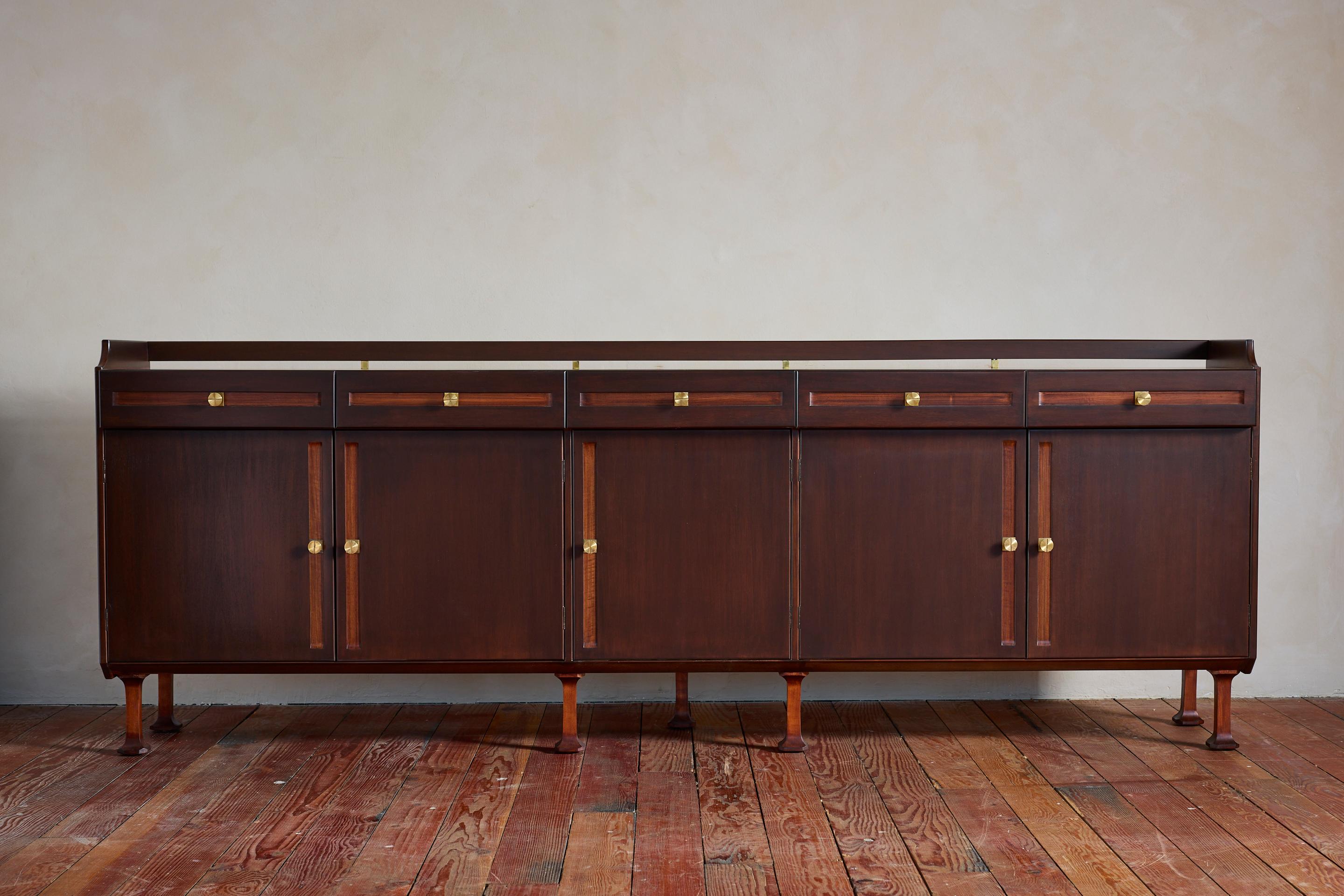 Gorgeous Italian sideboard by Mobili d'Arte Cantù - 1950's 

Impressive in size and extremely well made 

Newly refinished in 2 tone per the original with solid brass detailing and hardware. 

Cabinet sits on tapered flared legs and provides ample